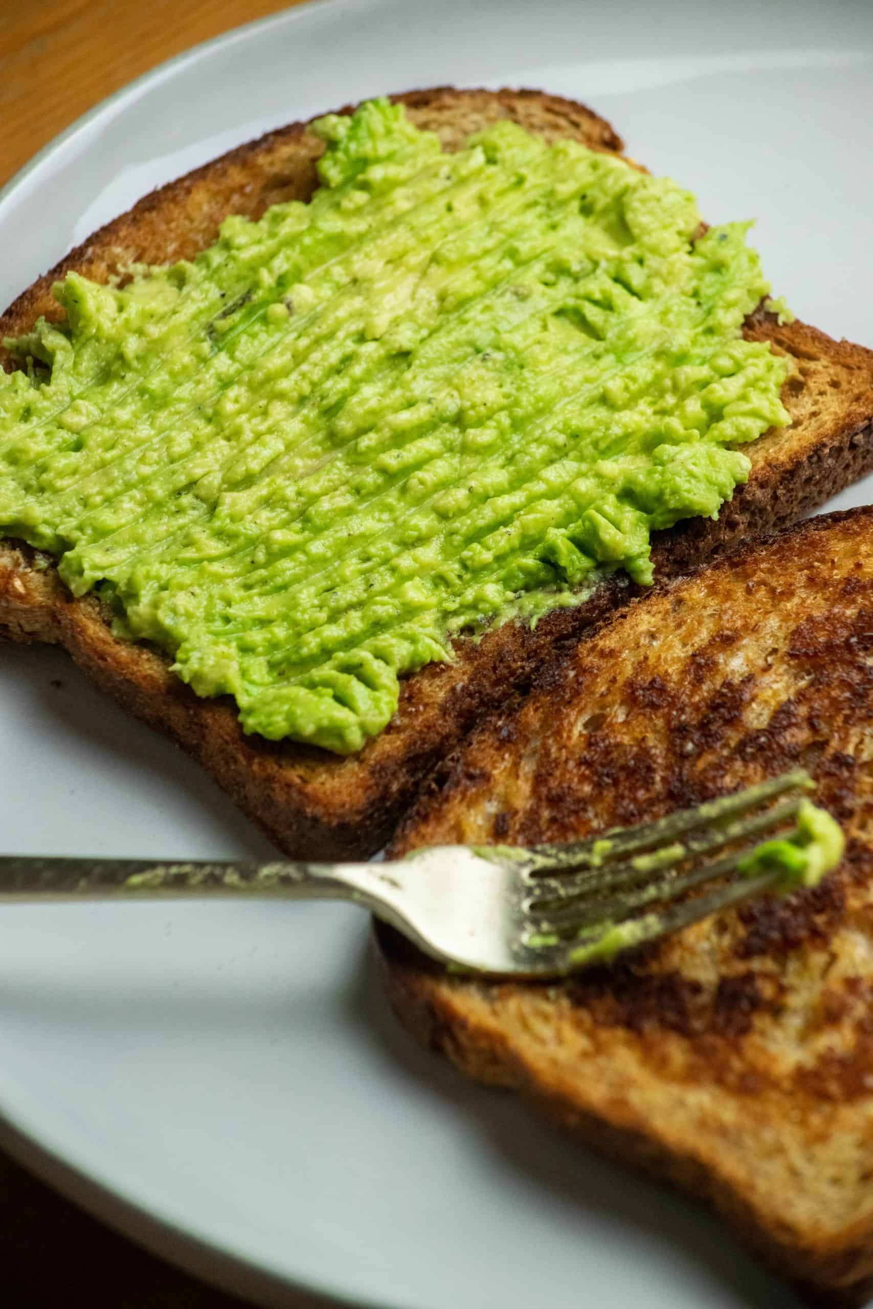 Spread on the toast. Spoon the mashed avocado onto the toasted bread and spread evenly.