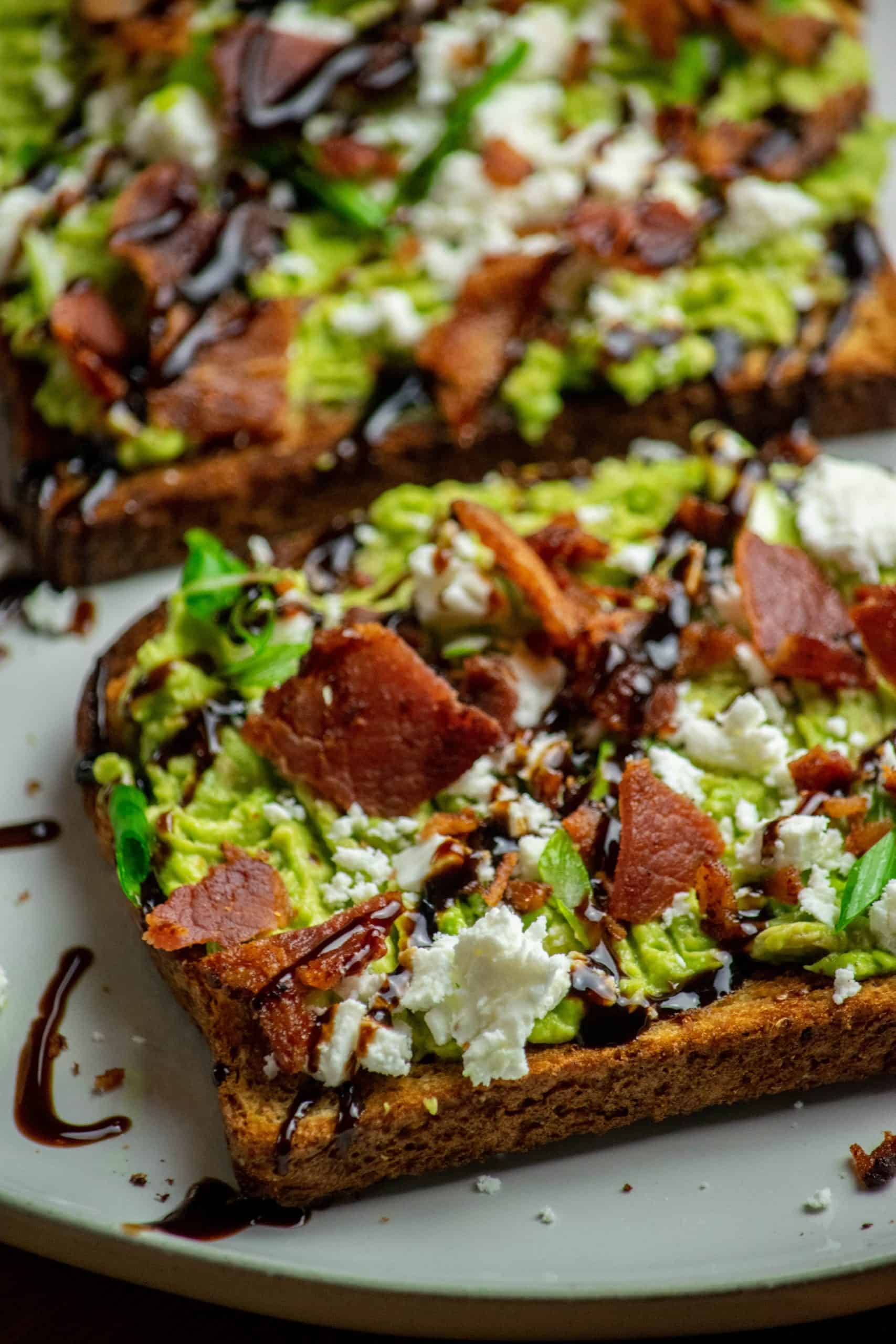Top and finish. Add the chopped bacon, crumbled feta, and sliced scallions, then drizzle with balsamic glaze and serve right away.