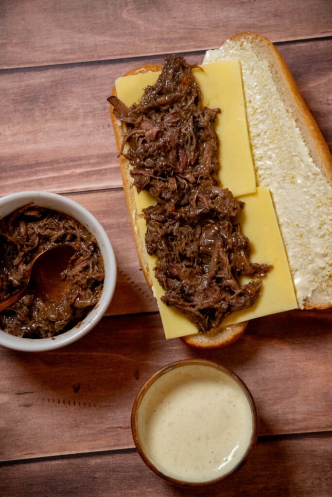 Add the pot roast to the sandwich, using tongs or a slotted spoon to leave excess gravy behind 