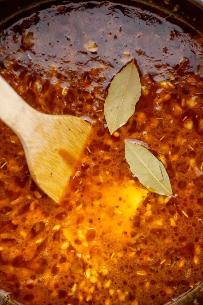 stir in broth, farro, beans, bay leaves, water, and parmesan rind