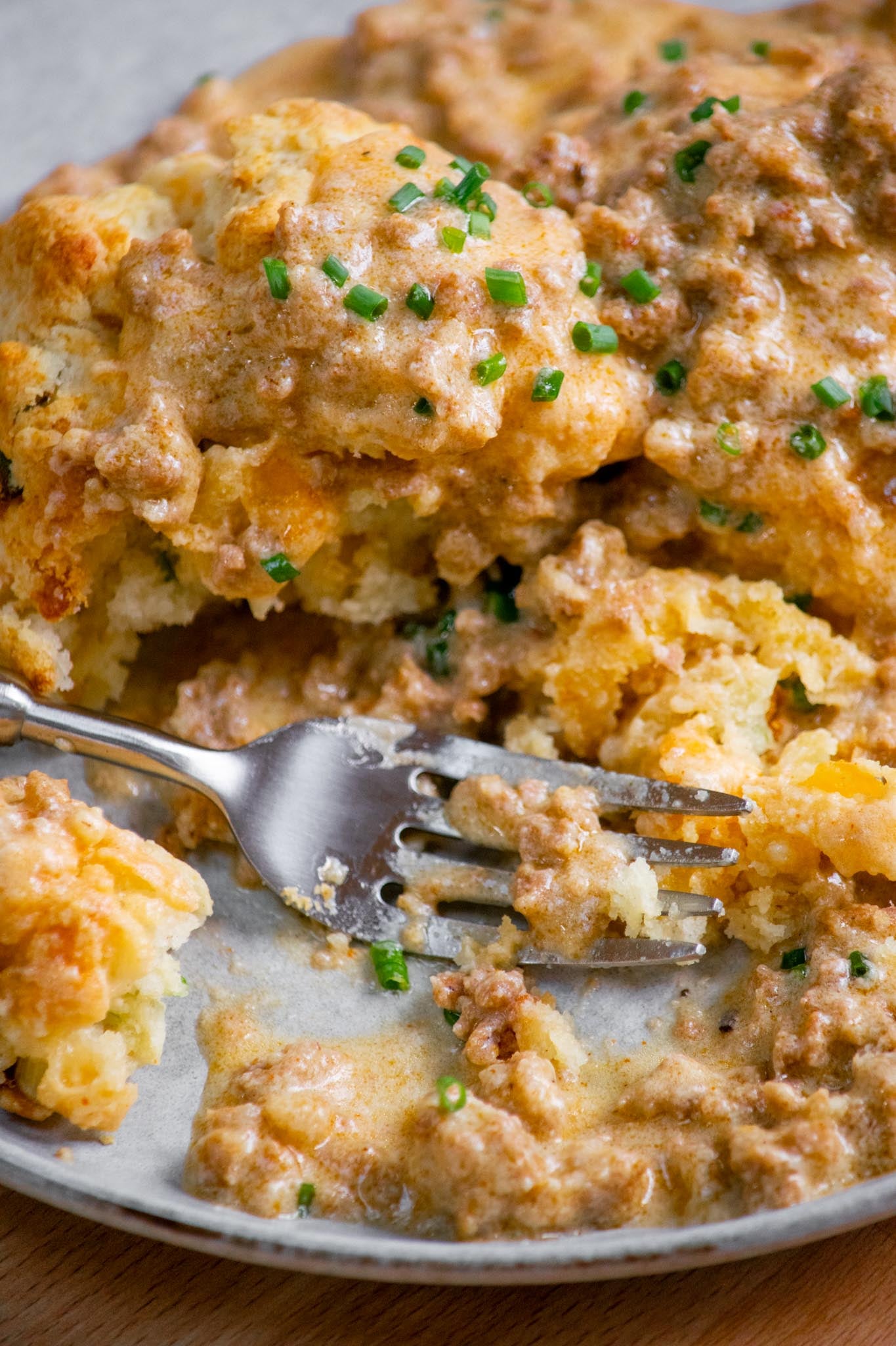 Chorizo breakfast gravy being eaten with biscuits. 