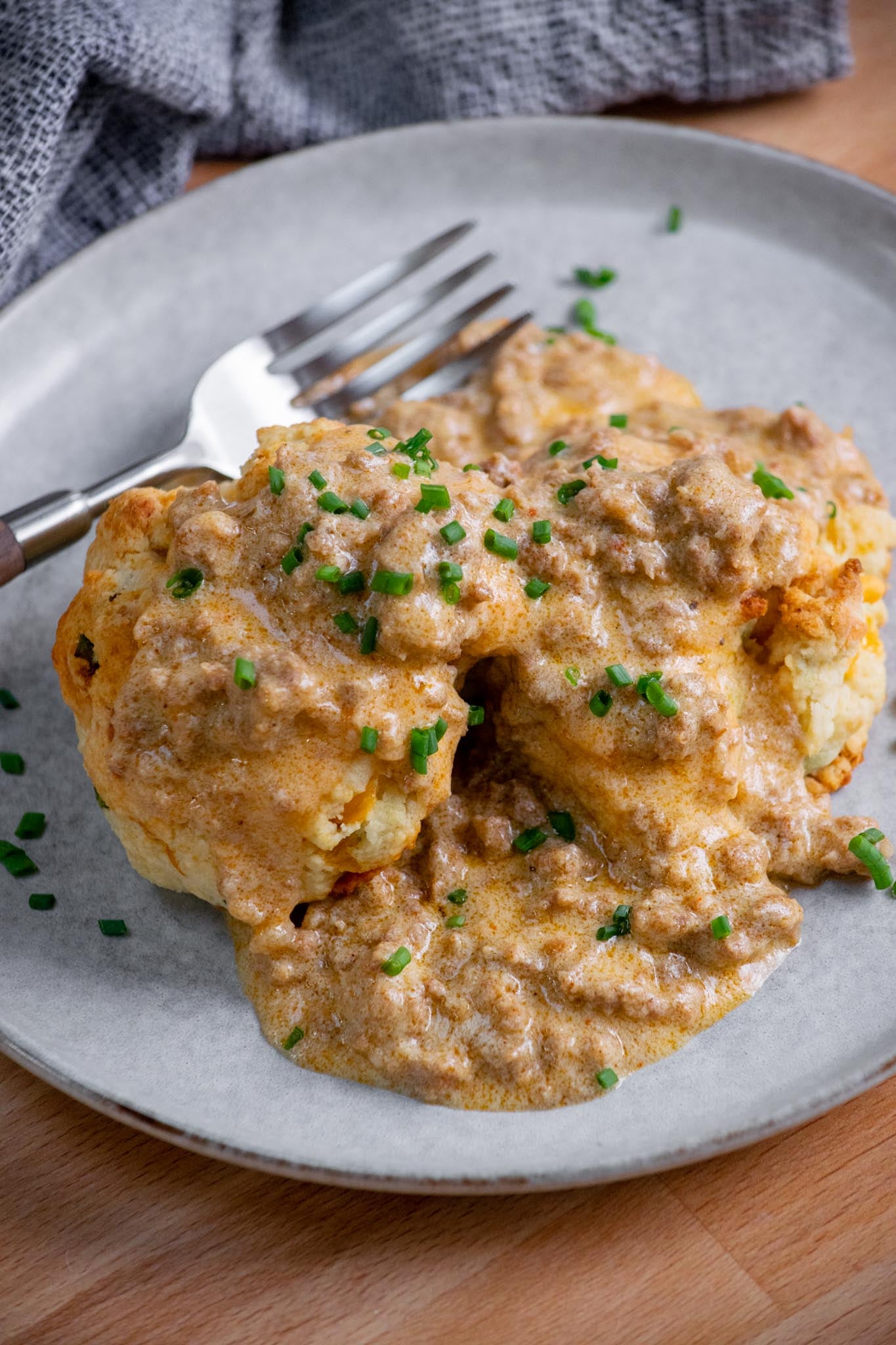 Serve the hot gravy over cheddar cheese biscuits or biscuits of choice, and top with chopped scallions or chives, if desired.