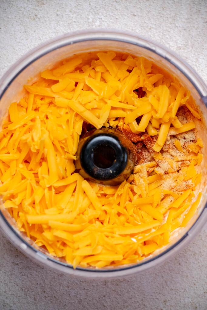 add shredded cheddar and spices, and pulse briefly in food processor, until just combined, or fold in your bowl with a spatula. 