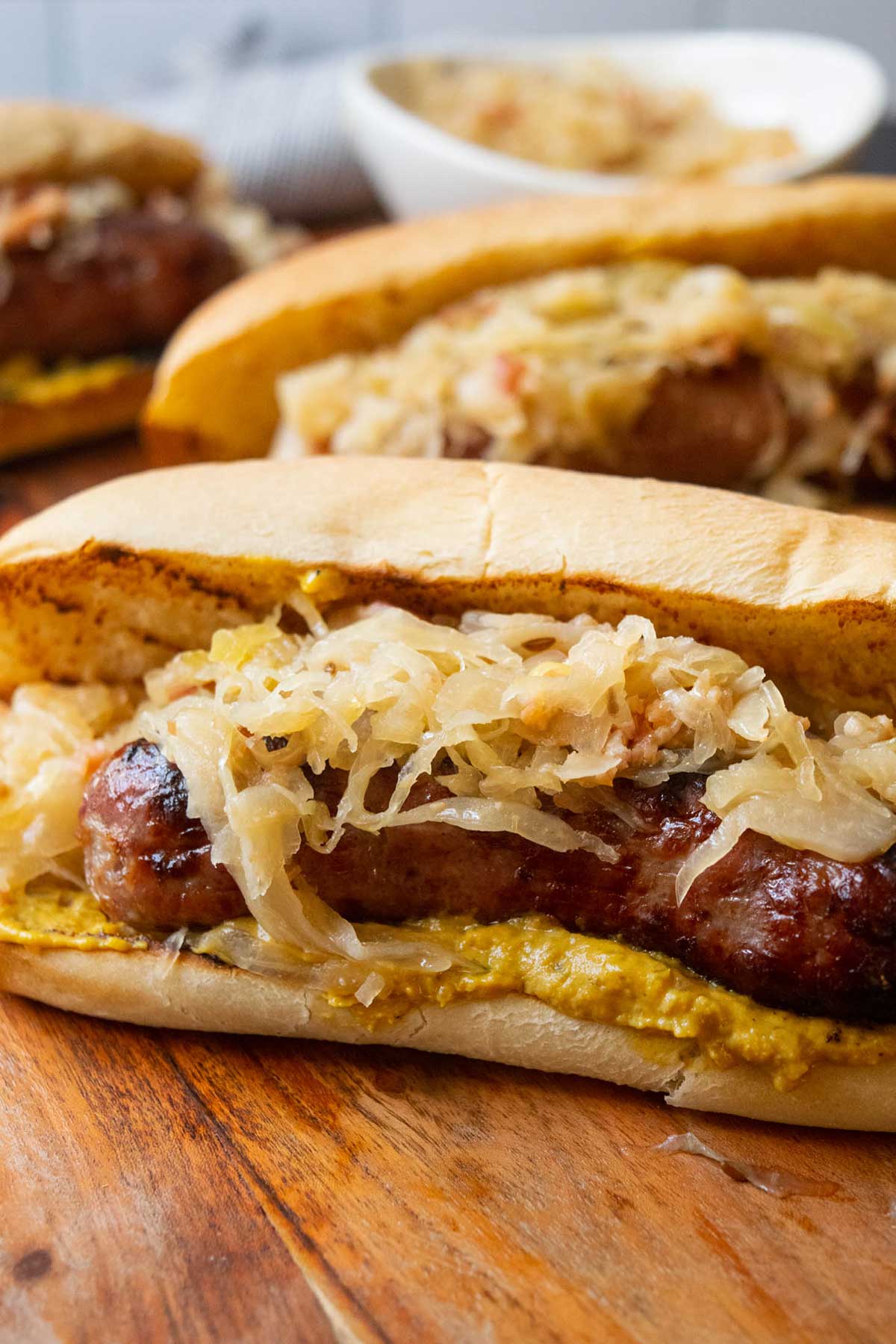 Beer Bacon Sauerkraut on a bun with bratwurst and mustard.  