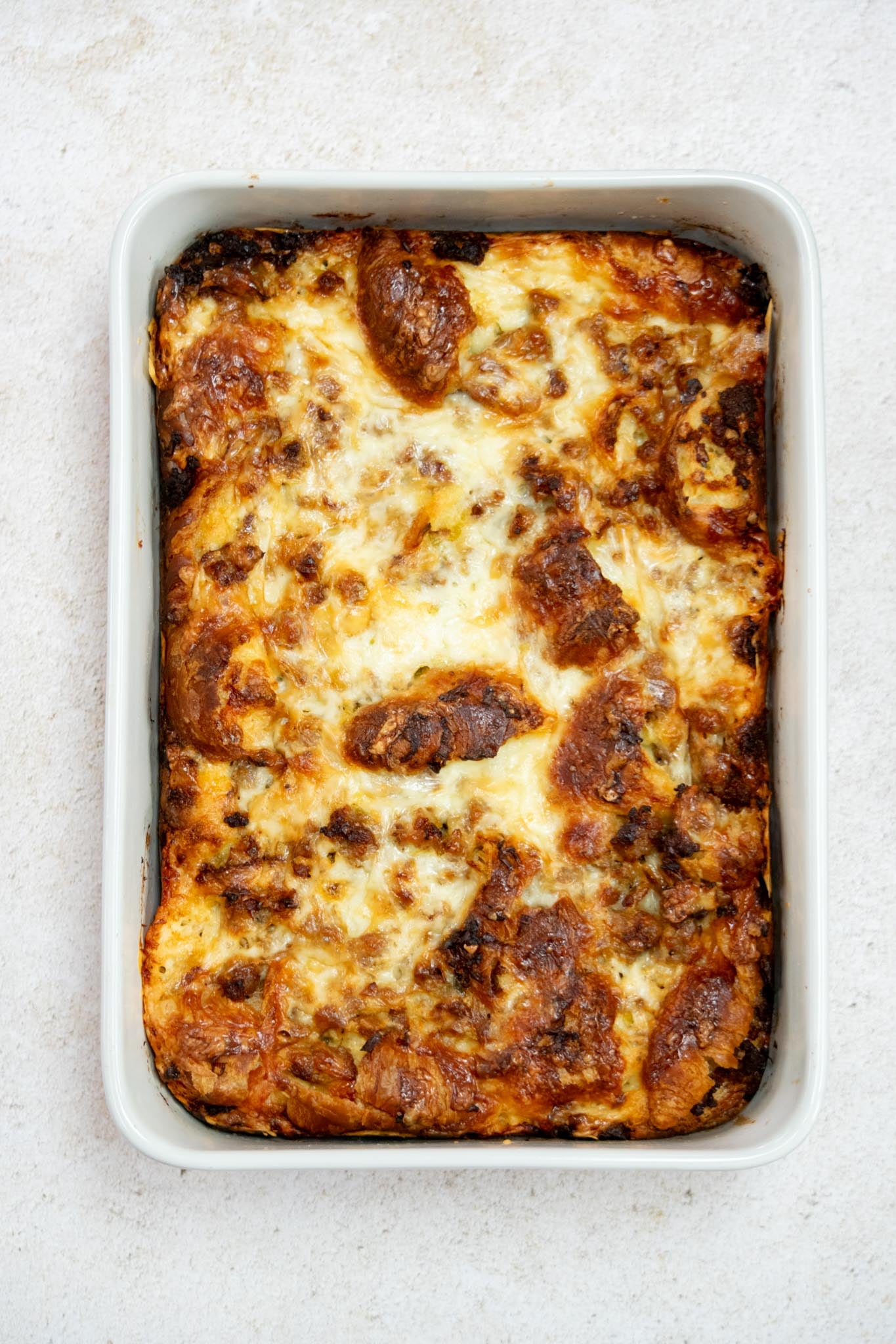 Bake. The next morning, remove the casserole from the refrigerator while the oven preheats to 375°F. Bake covered for 30 minutes, then uncover and bake another 25–30 minutes, until golden brown and set in the center.