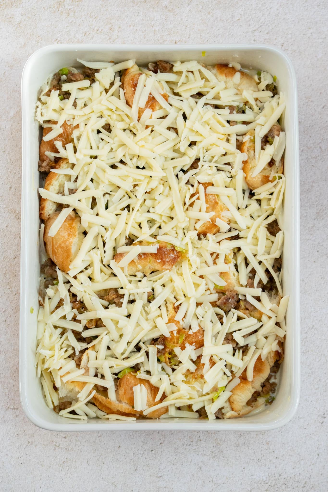 Add the cheese and chill. Sprinkle the shredded Gruyère over the casserole, cover tightly with foil and refrigerate overnight.