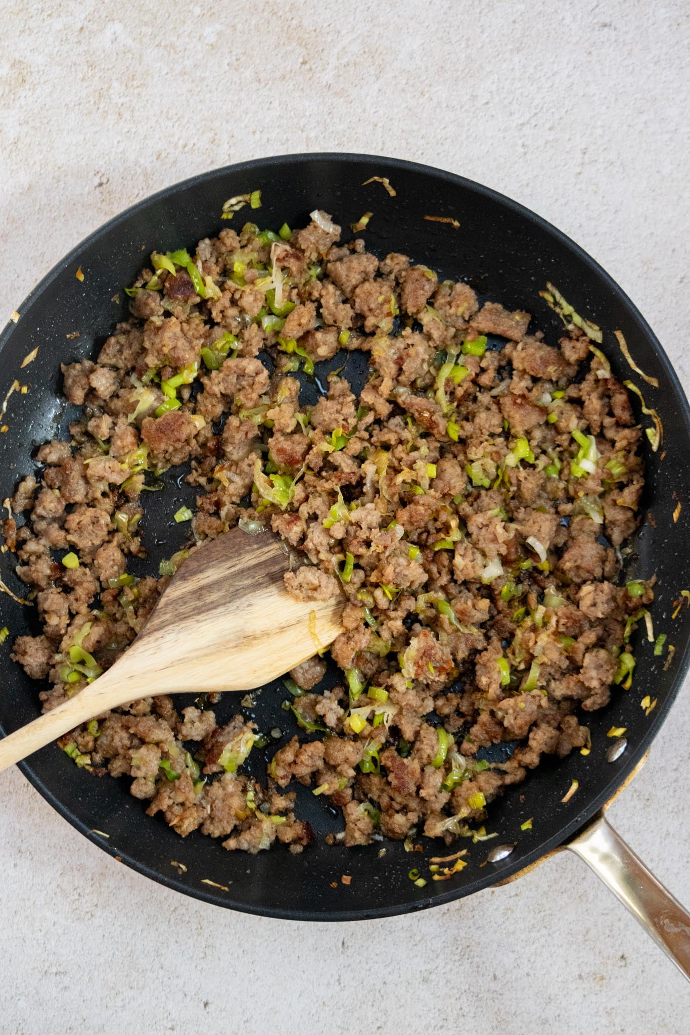 Cook the sausage and leeks. Brown the breakfast sausage in a skillet, breaking it into crumbles as it cooks. Add the sliced leek and cook until softened.