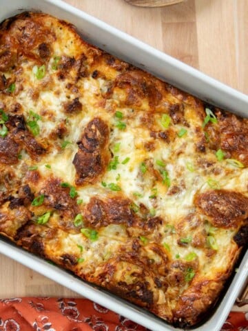 Overhead view of croissant breakfast casserole with sausage, leeks and melted Gruyère cheese.