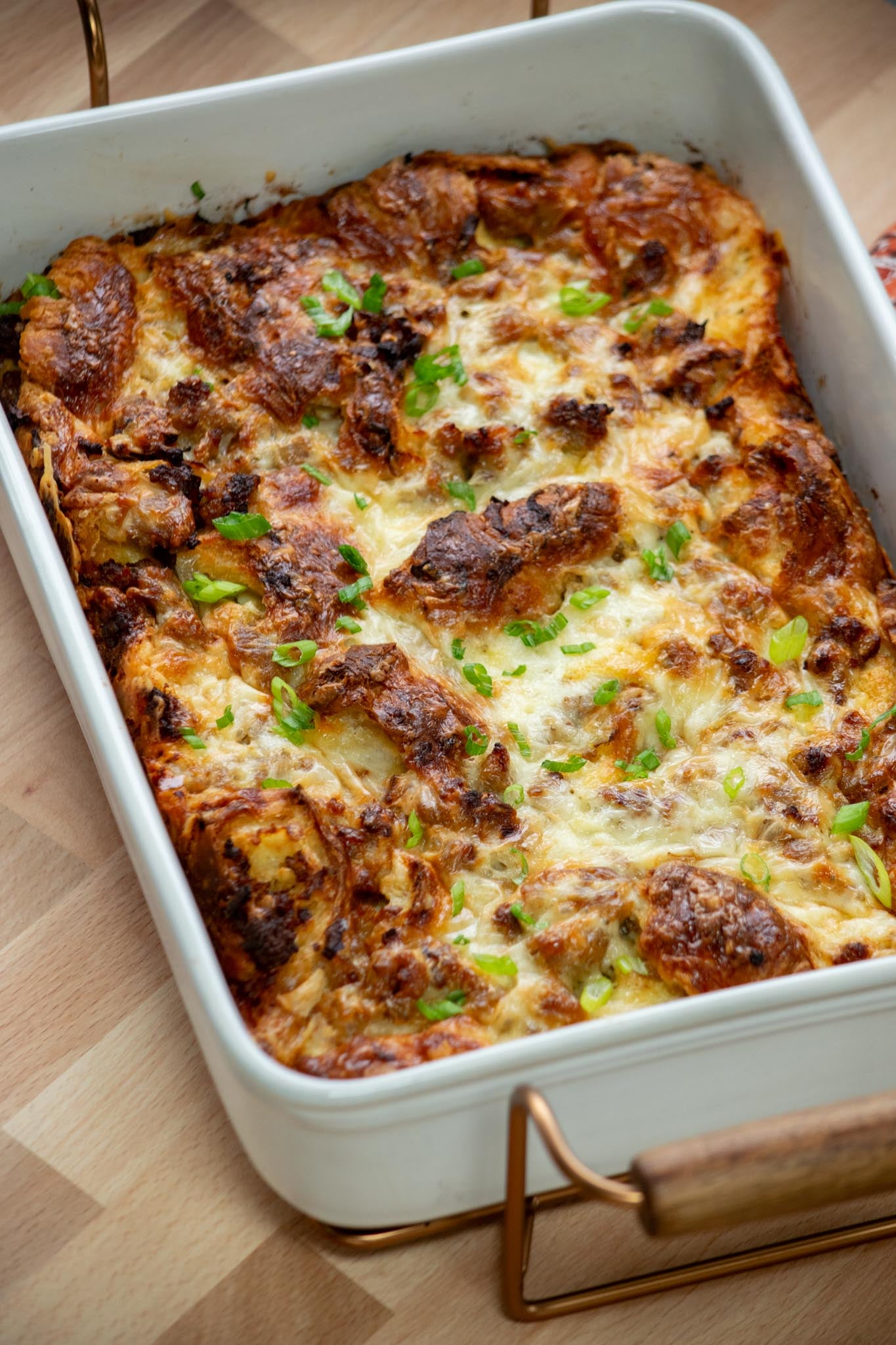 Golden croissant breakfast casserole with sausage, leeks and melted Gruyère.