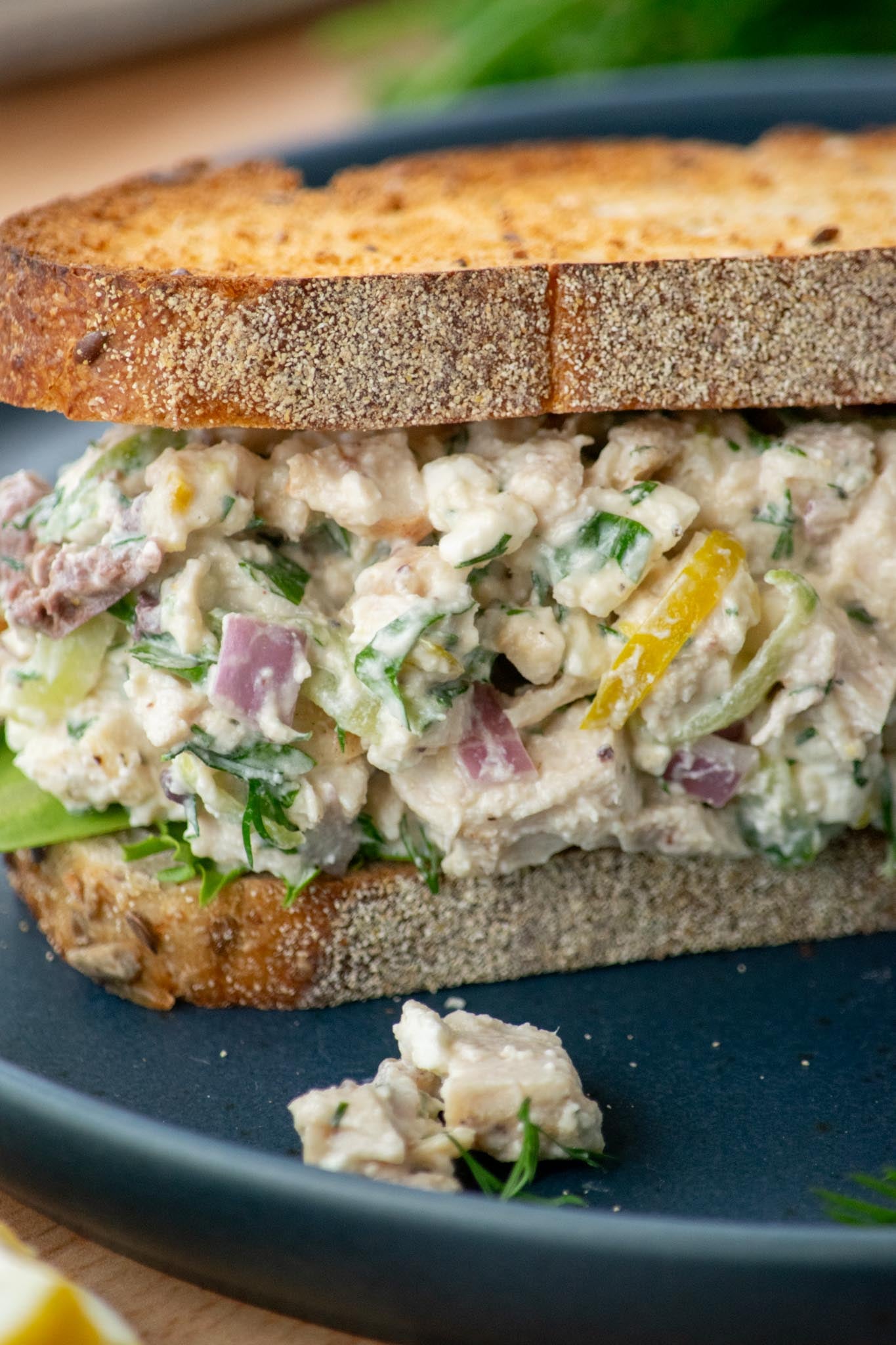 Closeup view of Greek Yogurt Chicken Salad piled onto toasted sandwich bread.