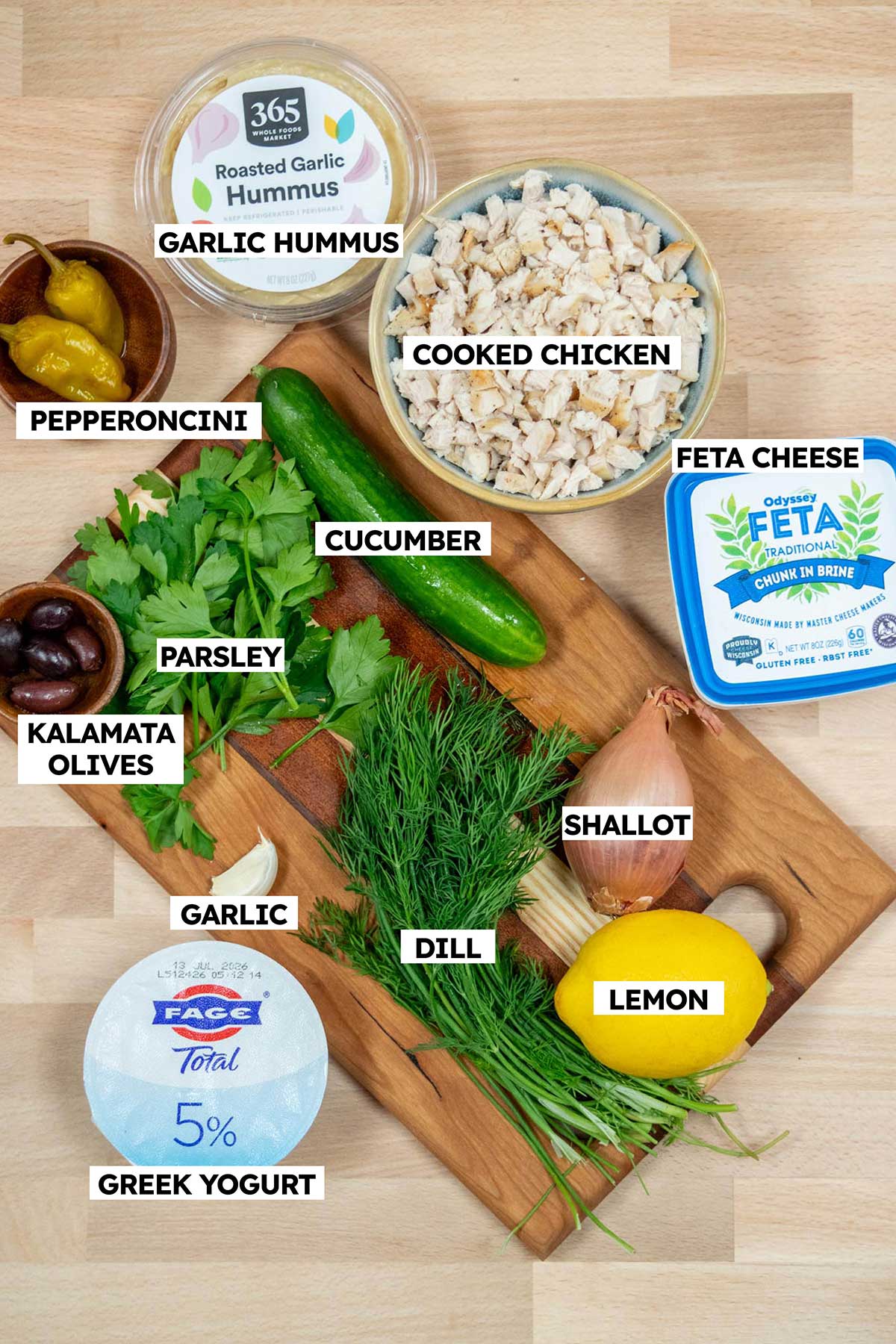 Greek Yogurt Chicken Salad Ingredients- fresh herbs, hummus, Greek yogurt, feta, lemon, olives, pepperoncini, chicken.