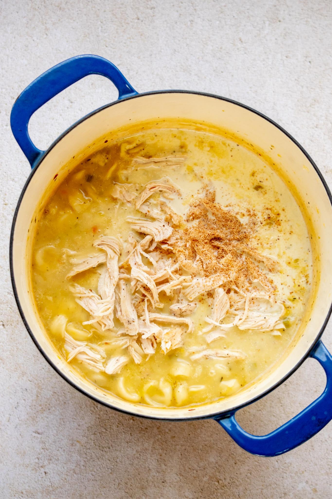 Finish the soup. Stir in the cooked chicken, heavy cream, and freshly grated nutmeg. Cook for another 3–5 minutes, until the chicken is heated through and the tortellini are tender.