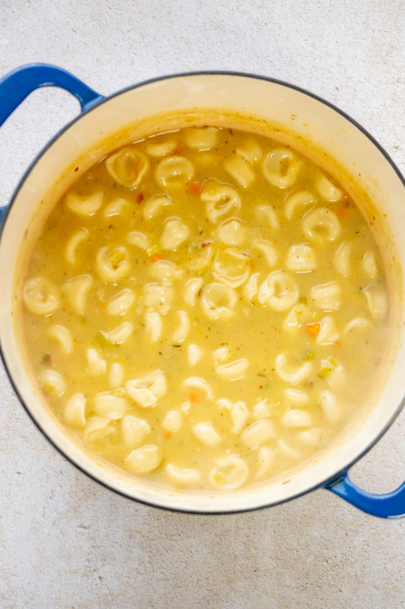 Cook the tortellini. Bring the soup to a boil, then reduce to a simmer and add the tortellini. Cook for 8–10 minutes, stirring occasionally, until almost al dente.
