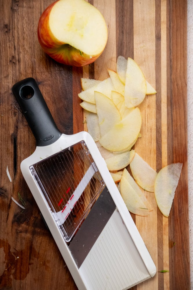 cut the apple away from the core, and thinly slice using the mandoline slicer or sharp chef's knife 
