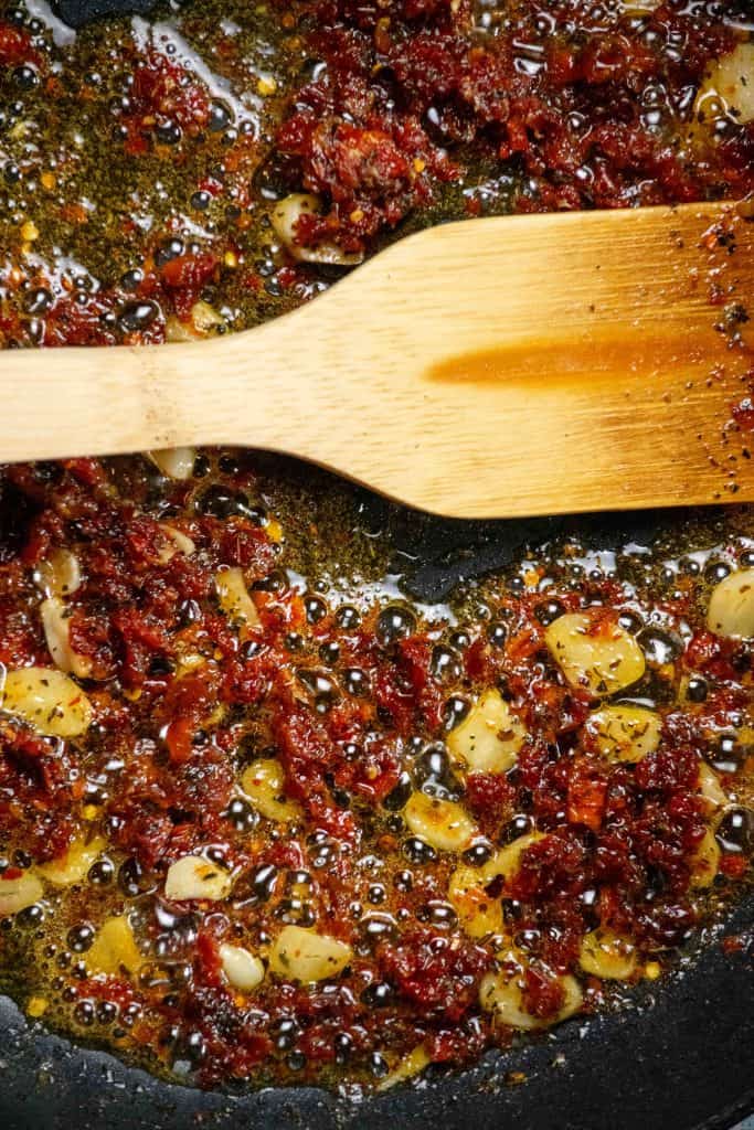 melt butter in same pan, and add sun dried tomatoes, garlic, and spices. Cook 1 minute 