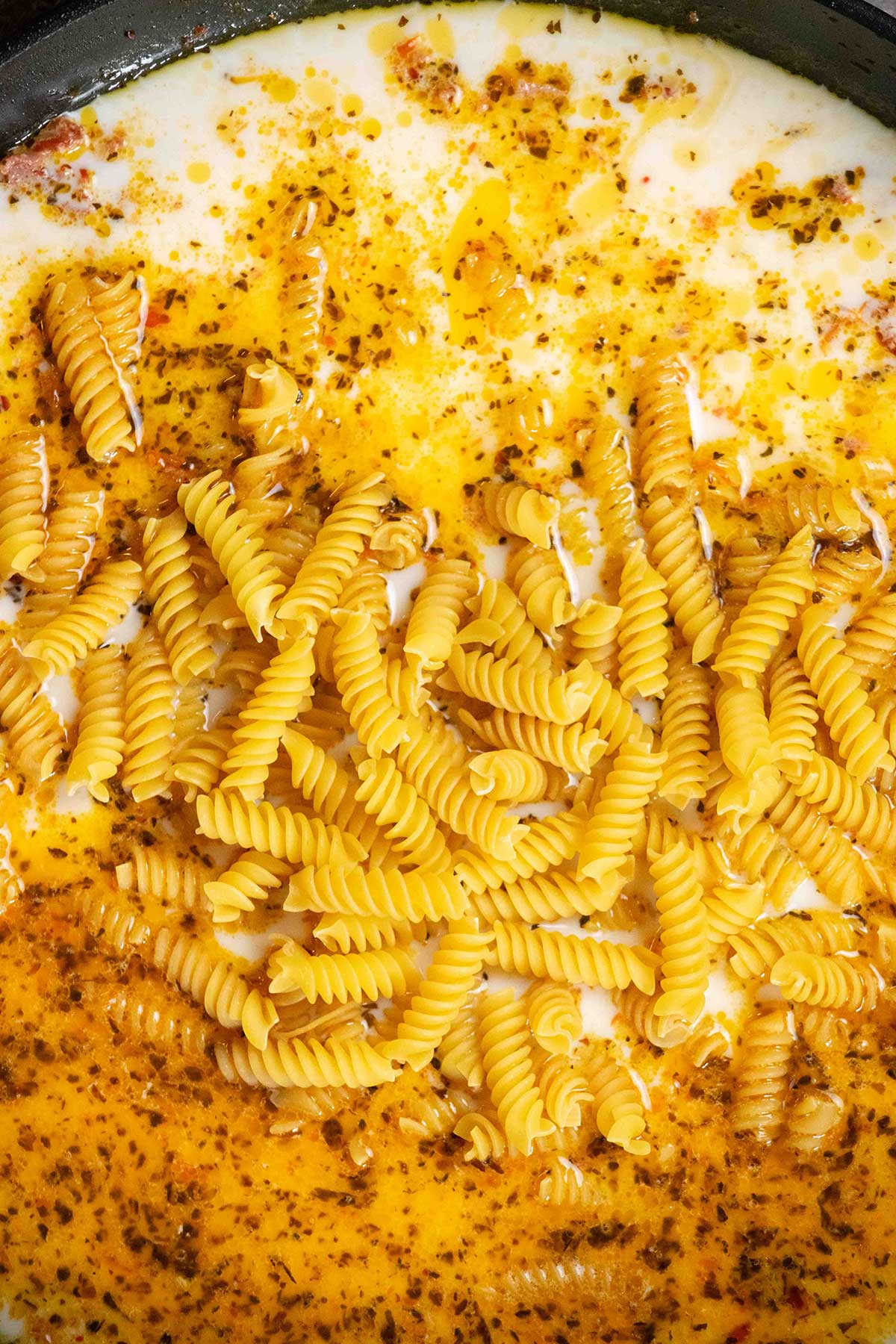 add stock, milk, and dry pasta