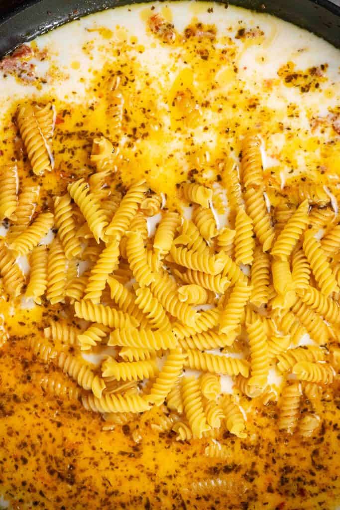 add stock, milk, and dry pasta