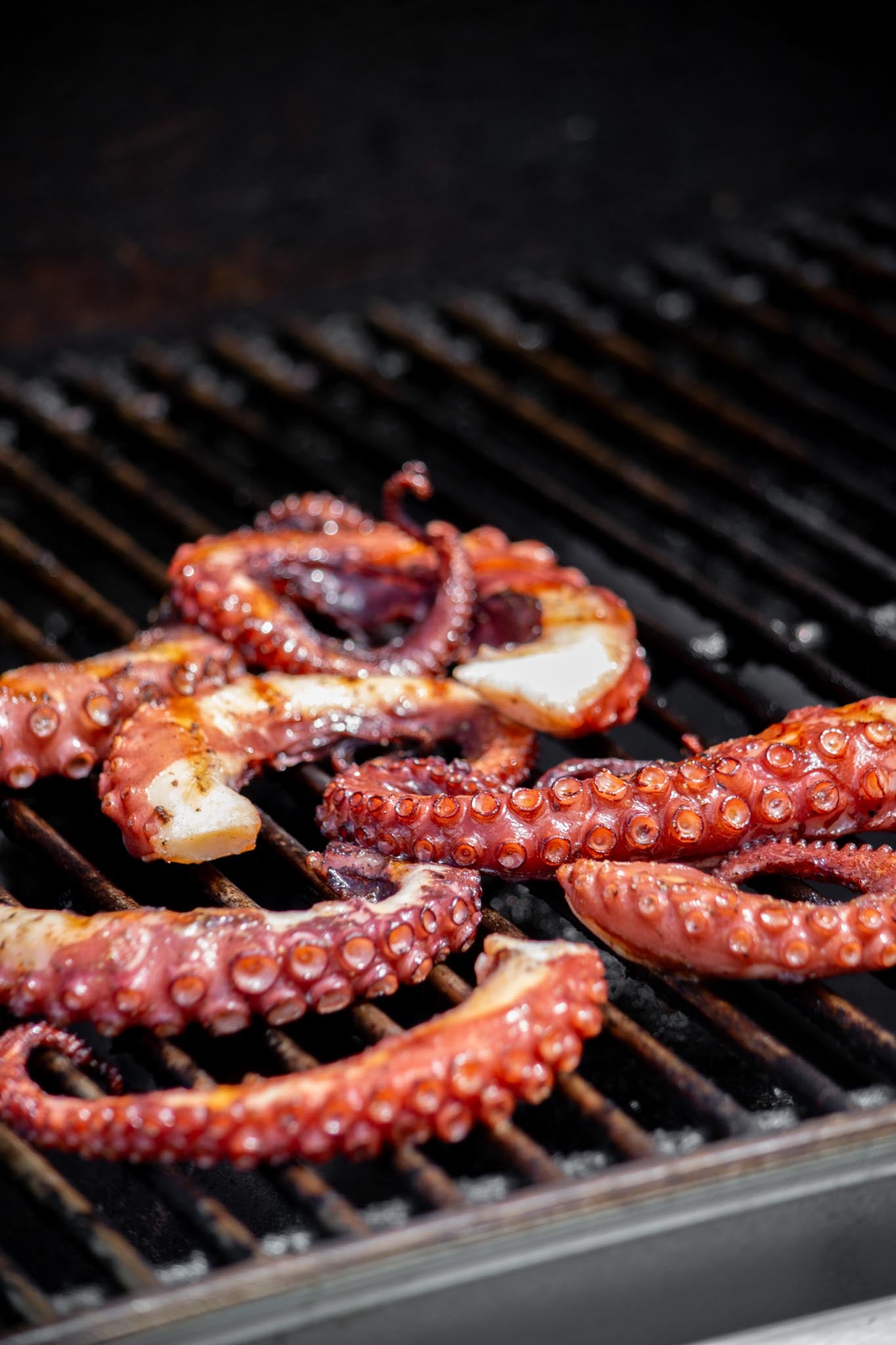 Coat octopus in olive oil, season with salt and pepper, and grill on preheated hot grill for 2-3 minutes a side.