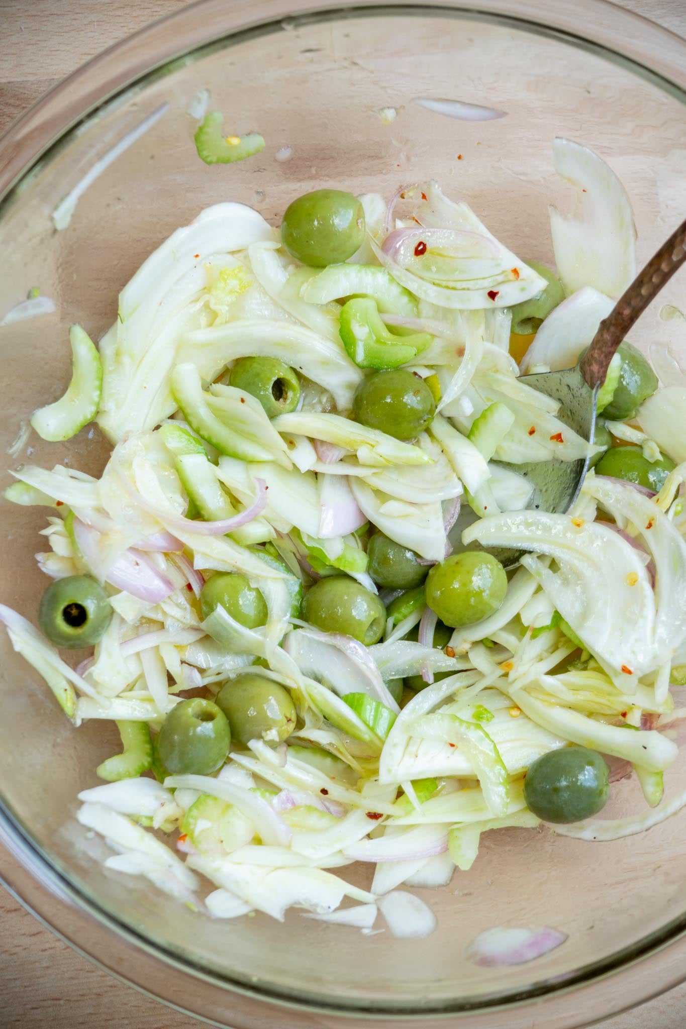 Add fennel, shallot, celery, and pitted olives to a bowl. Toss to combine with dressing. Set aside.
