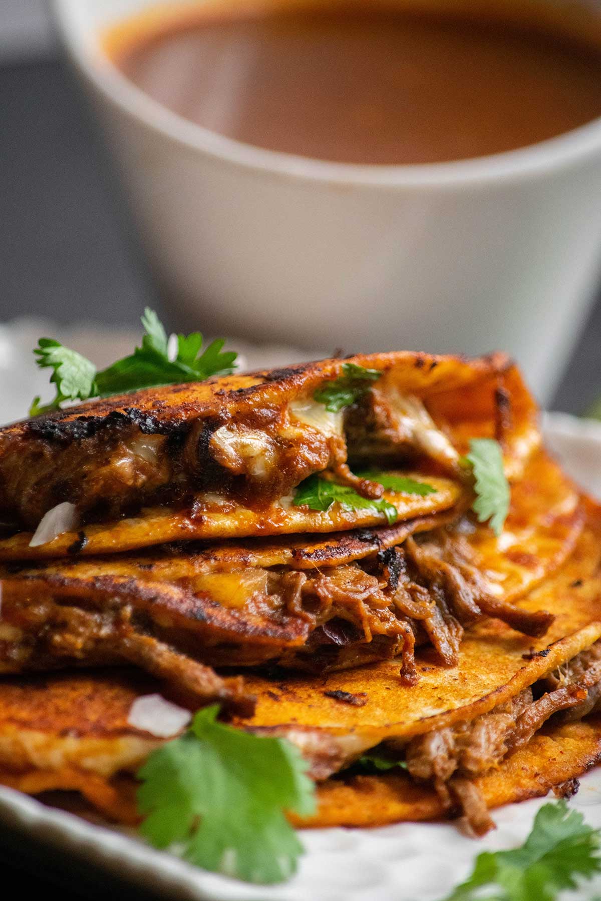 Plate of Crock Pot Birria Tacos with dip.