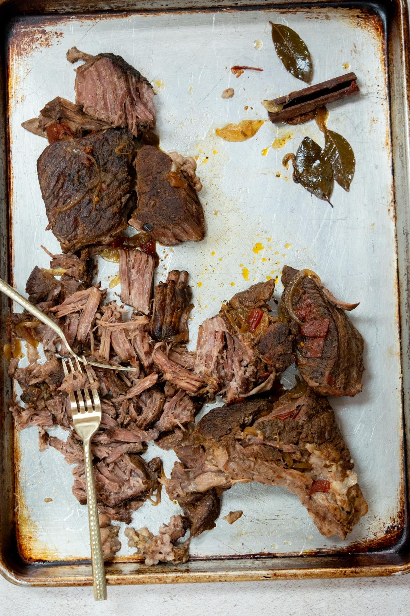 Step 4: Shred the beef. Transfer the cooked beef to a cutting board or sheet pan, remove any large pieces of fat, and shred it with two forks.