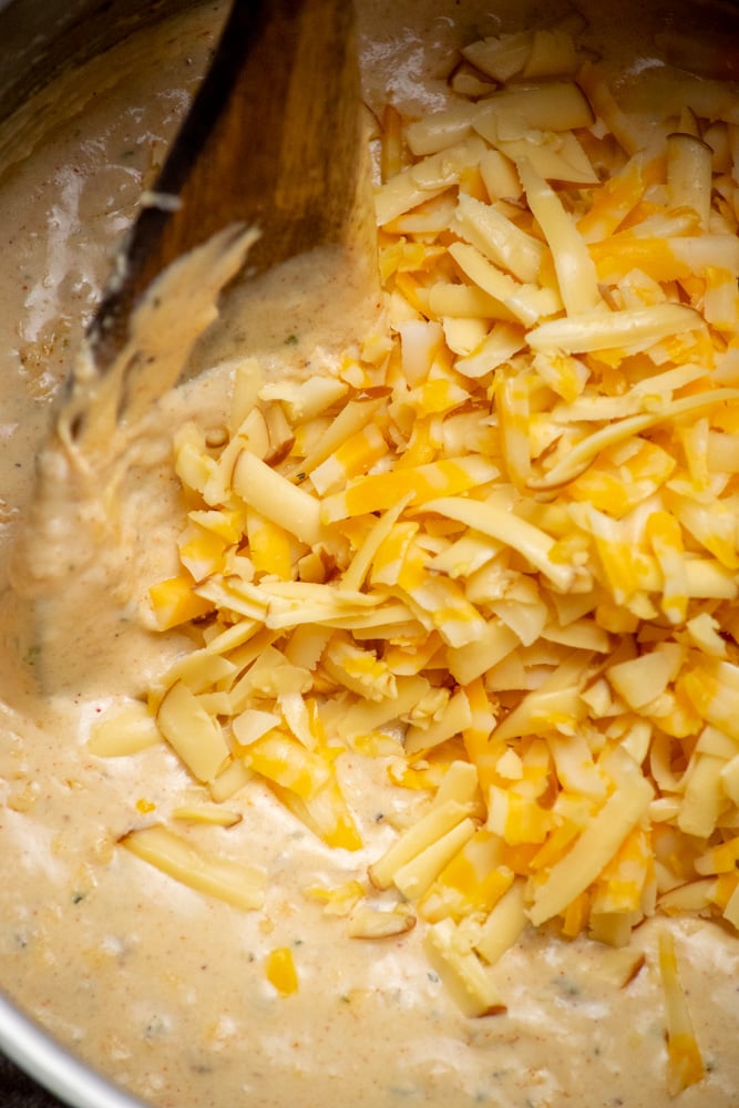 once sauce is cool, fold in half the Colby Jack and Smoked Gouda