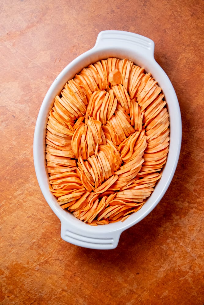 while your sauce cools, spice potatoes, and arrange in a greased casserole dish