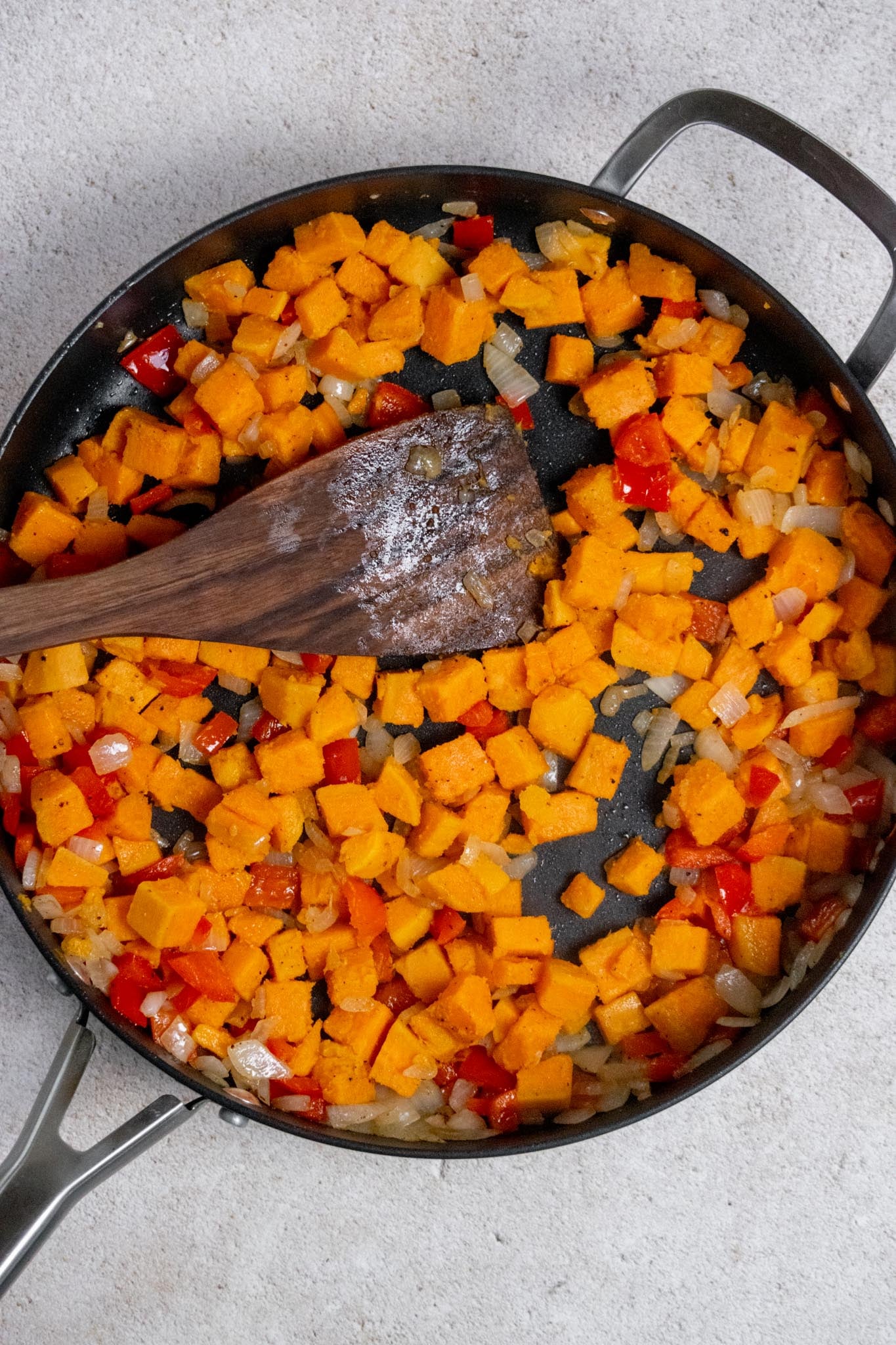 Add the sweet potatoes. Add the drained sweet potatoes to the skillet and cook for another 3–5 minutes, until the vegetables are tender. Push everything toward the outside edges of the skillet to make room in the center.