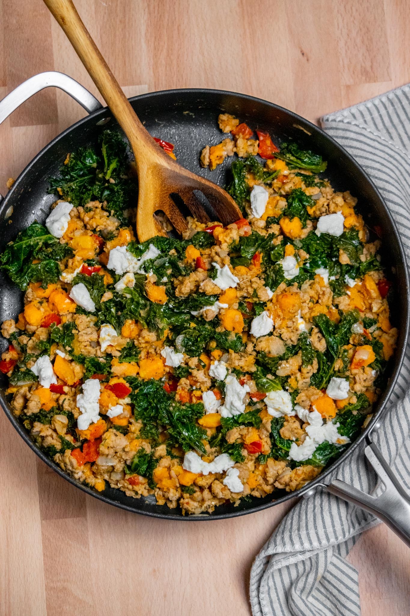 Ground turkey skillet meal with sweet potatoes, kale, red peppers and crumbled goat cheese.