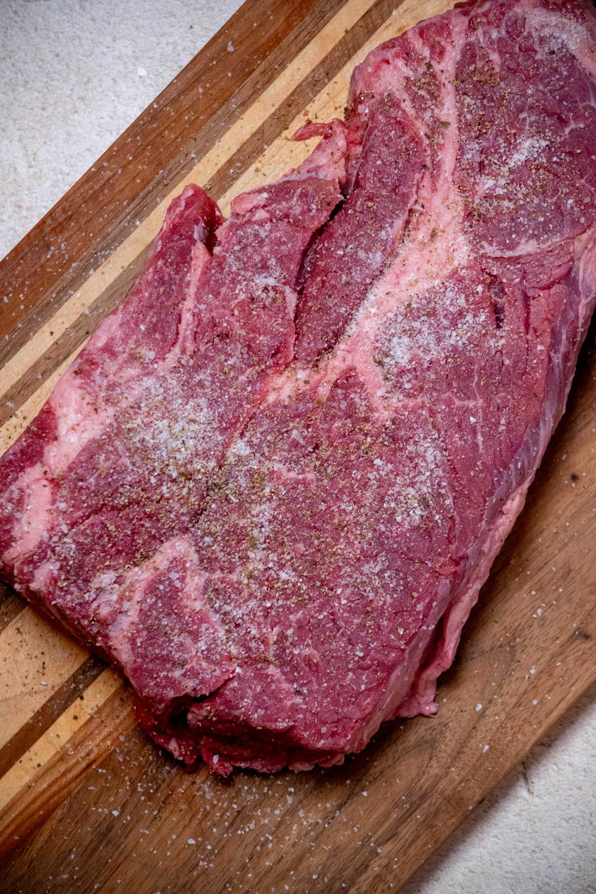Pat chuck roast dry with paper towels, and season liberally on both sides with salt and pepper.