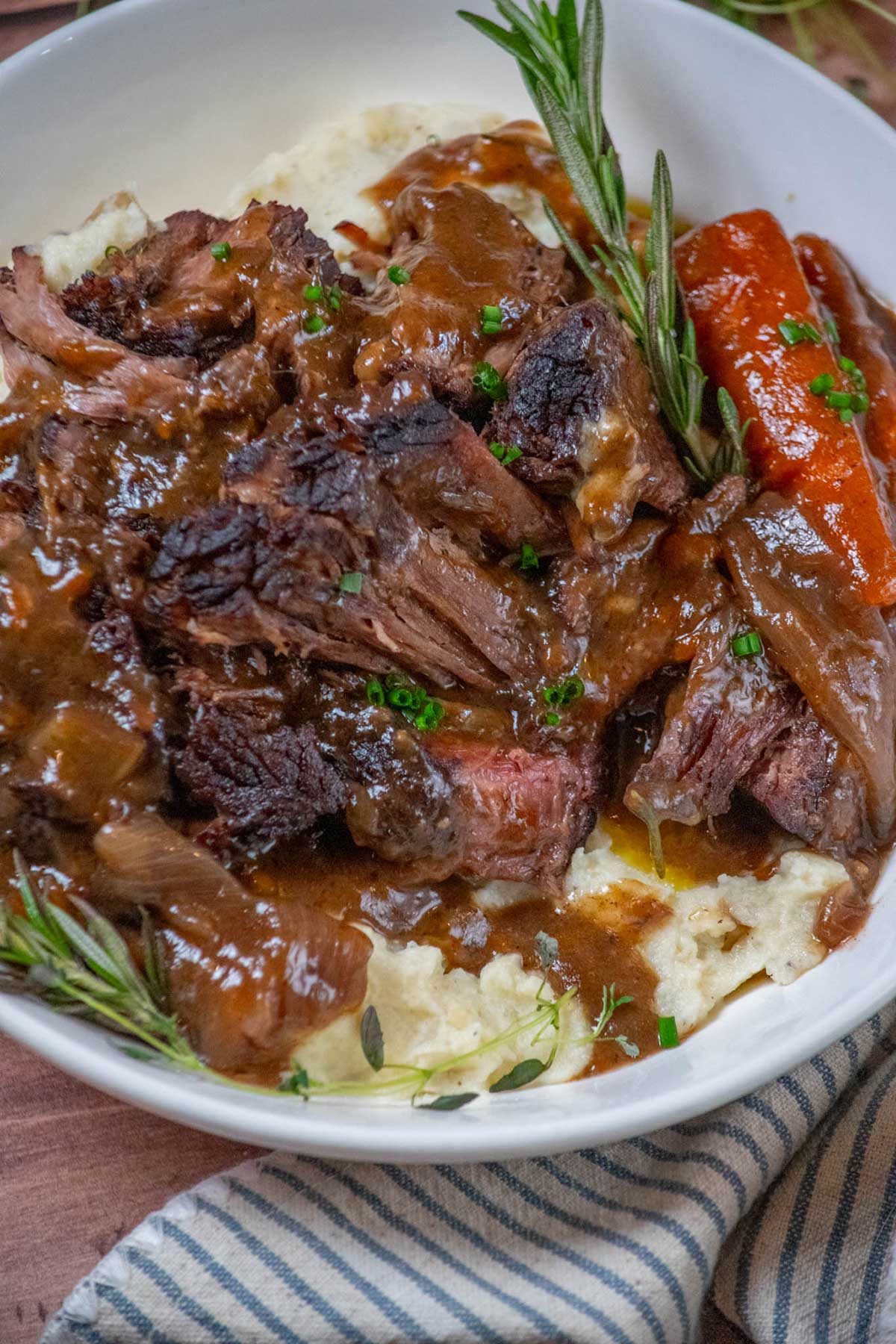 Dutch Oven Chuck Roast on a plate with gravy,.