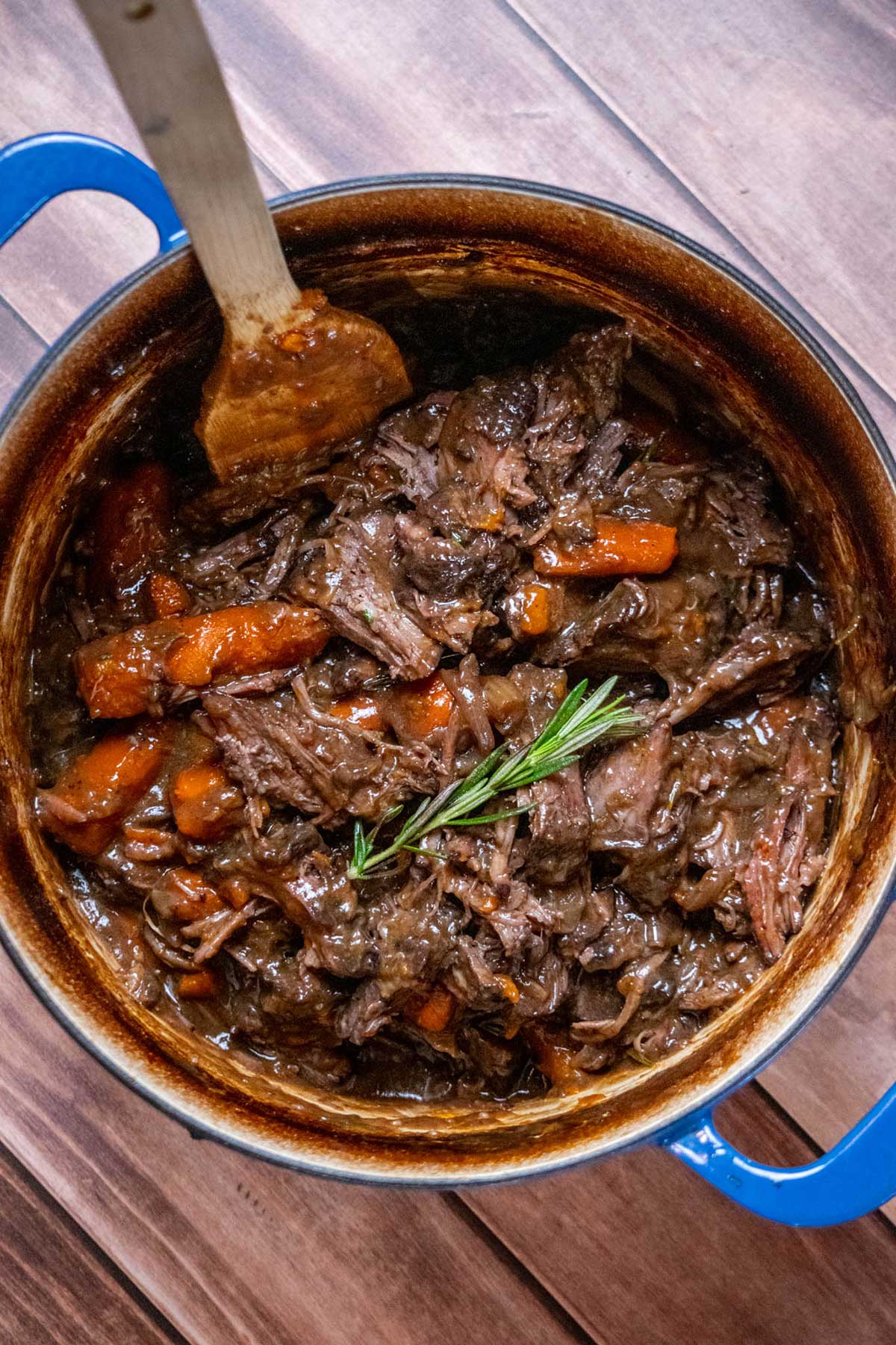 Dutch Oven Chuck Roast with carrots, herbs, and gravy.