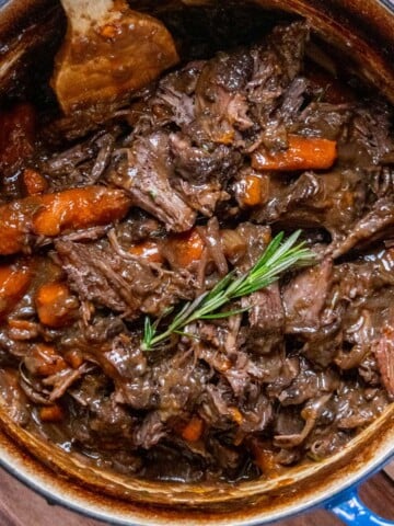Dutch oven chuck roast with carrots and gravy.