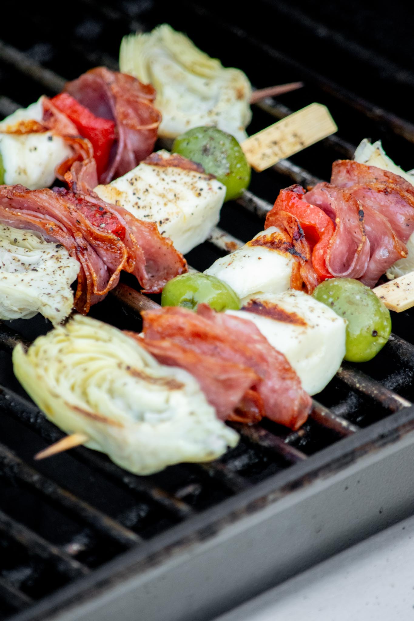 Grill for 2-3 minutes a side, until cheese is just charred, then transfer to a platter and drizzle dressing over while skewers are still warm. 