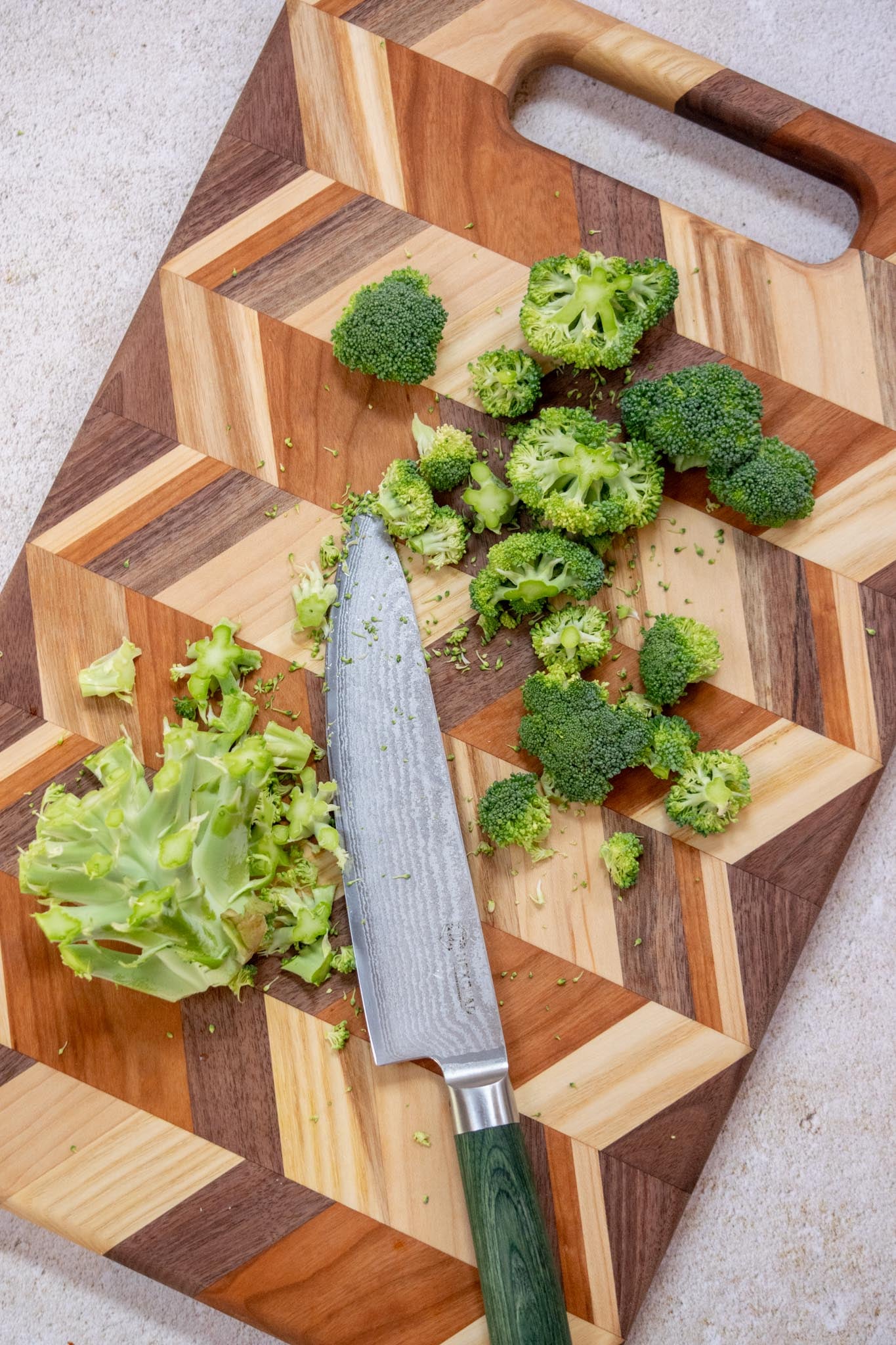 White the bacon cooks, cut the broccoli into small bite-sized florets, removing most of the stem for best finished salad texture. 