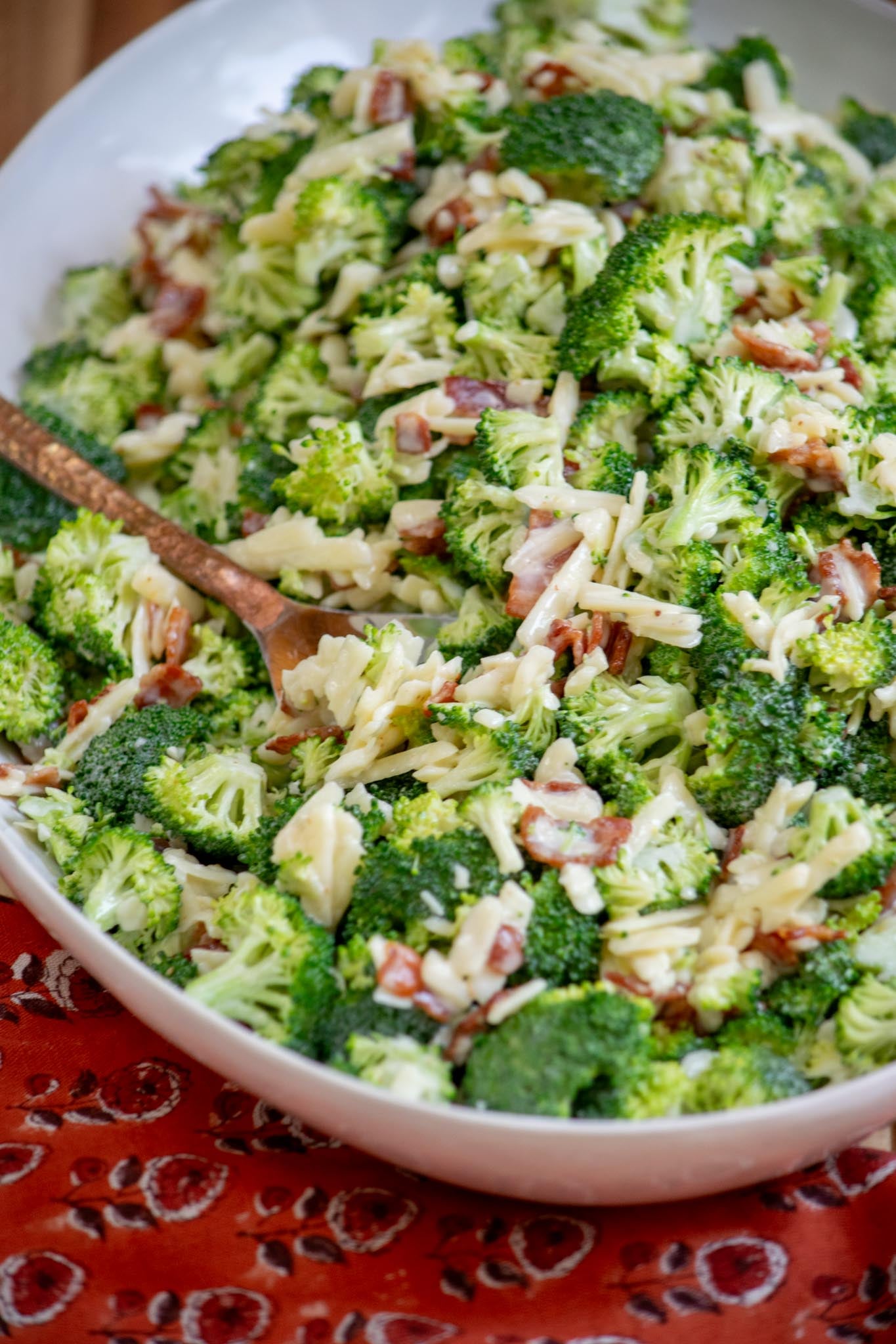 Bacon broccoli salad being served with a spoon. 