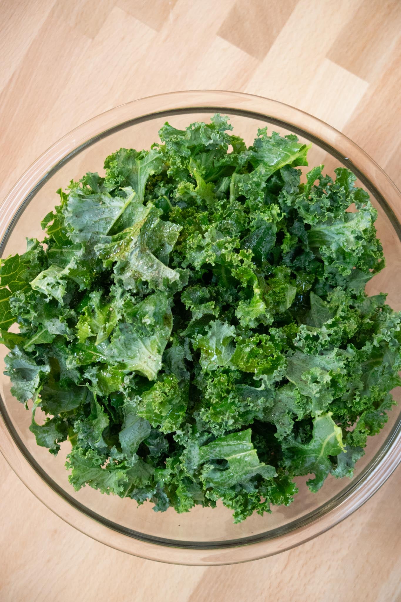 Remove tough stems from kale, remove leaves and chop or tear into small pieces, wash, dry, and add to a bowl.