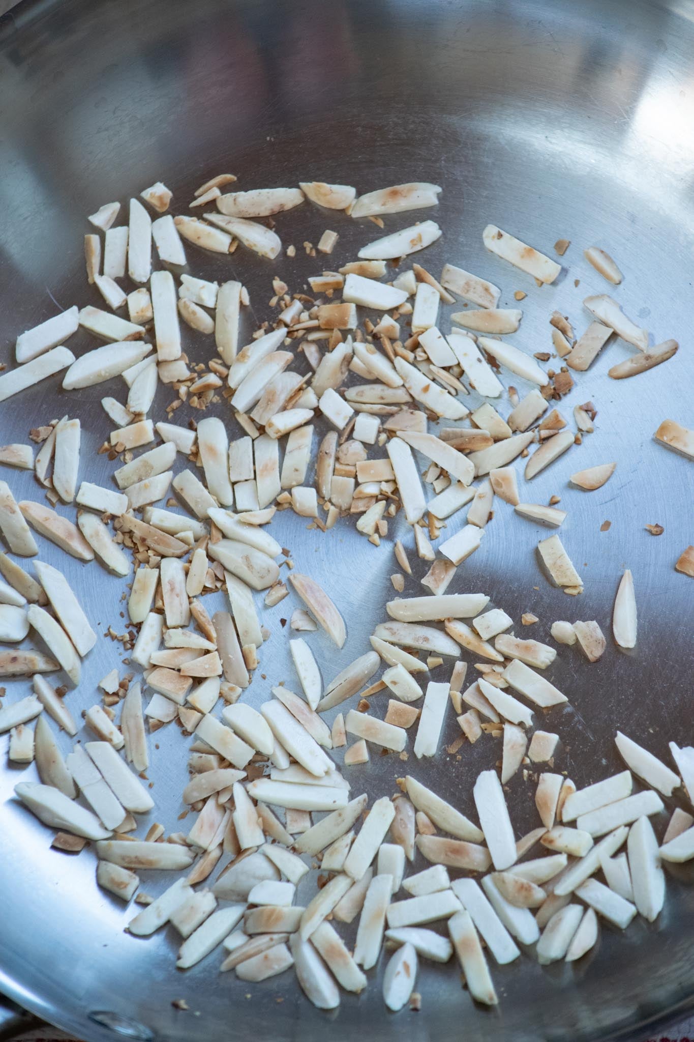 Toast the almonds in a dry pan for 5-7 minutes, moving the pan frequently, until just browned. Immediately remove to a plate to cool.