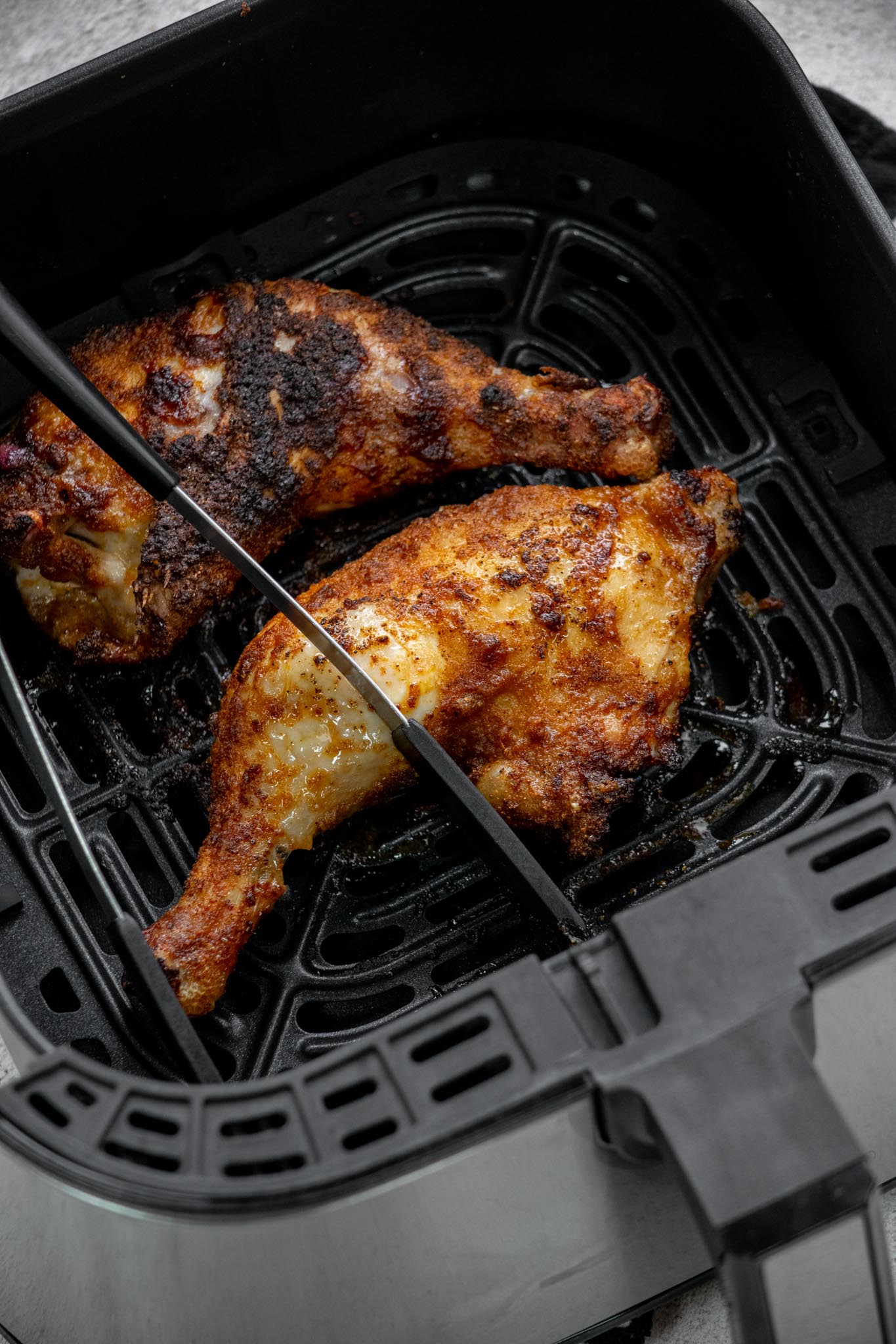 Flip over with tongs, and cook 10-15 minutes more, until a thermometer inserted in the thickest part of the thigh reaches 165°. 
