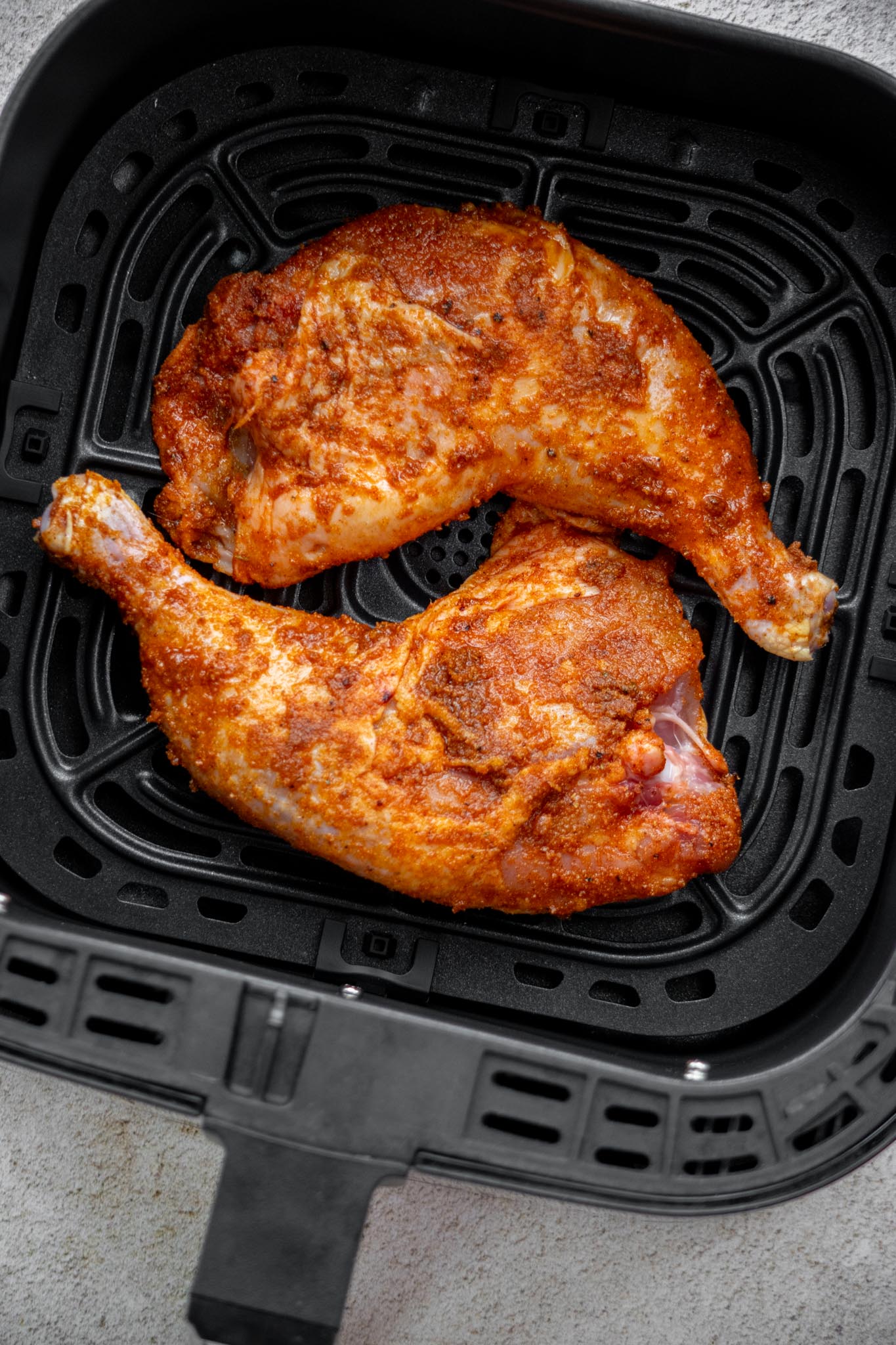 Start chicken quarters skin side down in a cold air fryer, and air fry for 15 minutes. 