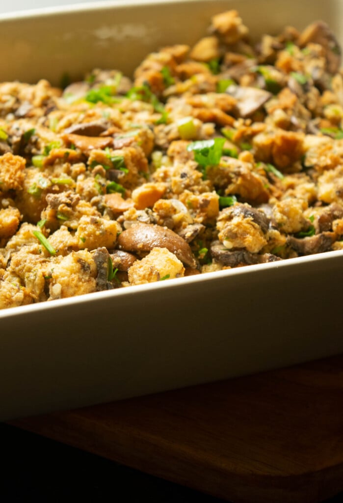 Transfer the mixture to a greased baking dish. Spread it out, being sure to make some wells and give it an uneven placement for better browning. 