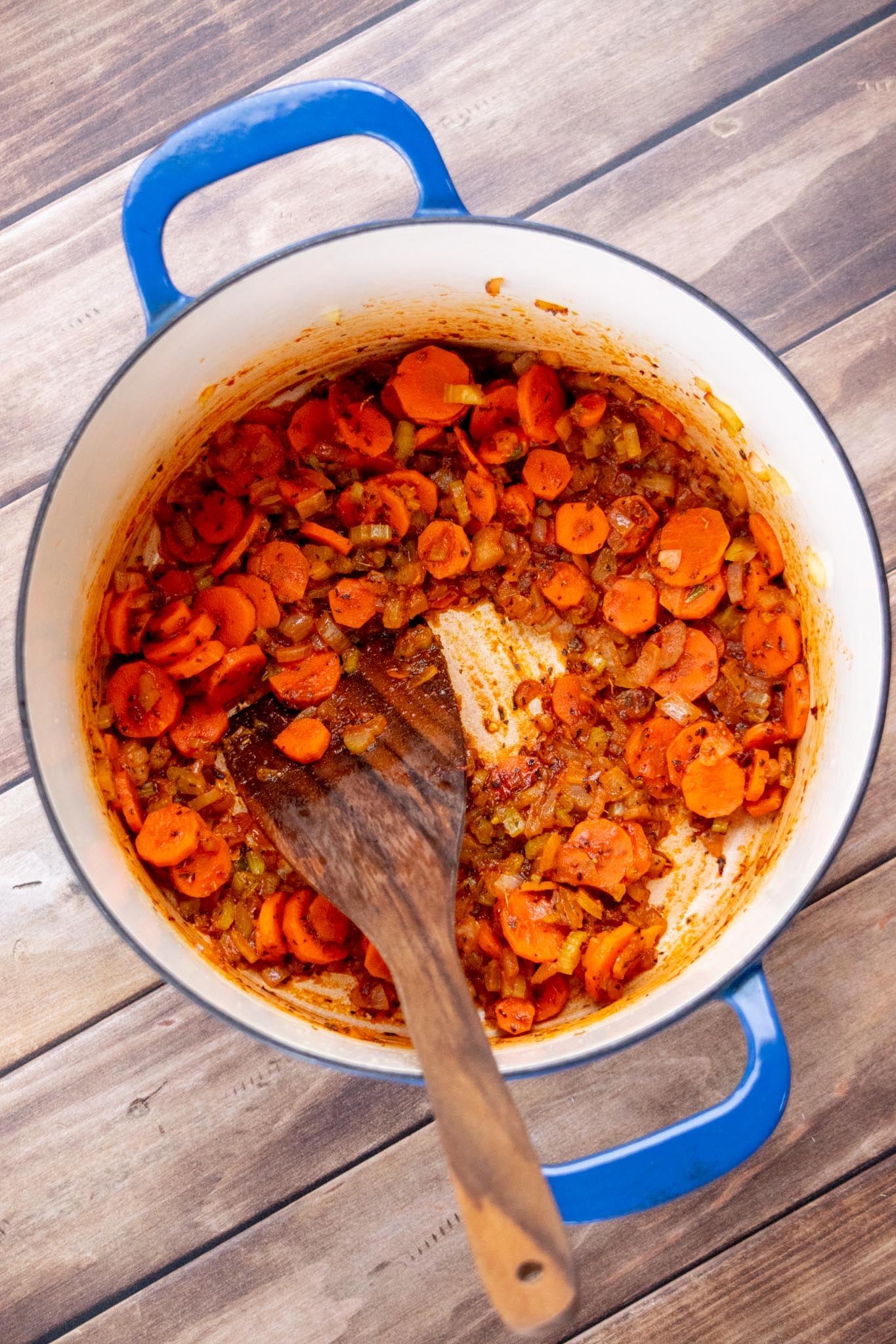 Sauté the vegetables. Heat olive oil in a large stockpot or Dutch oven over medium heat. Add the onion, celery, and carrots, season lightly with salt and pepper, and cook for 4–5 minutes, stirring occasionally, until the onions are translucent.