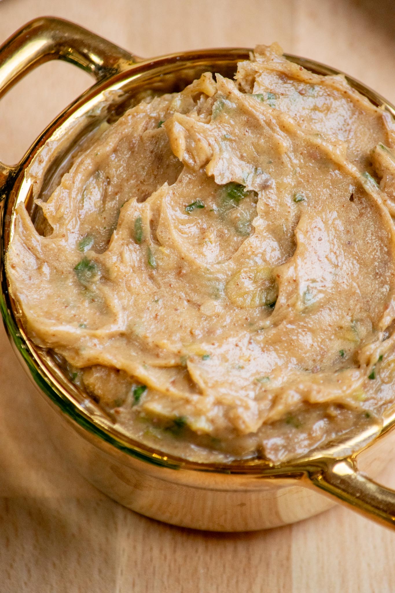 Closeup view of anchovy butter in ramekin.