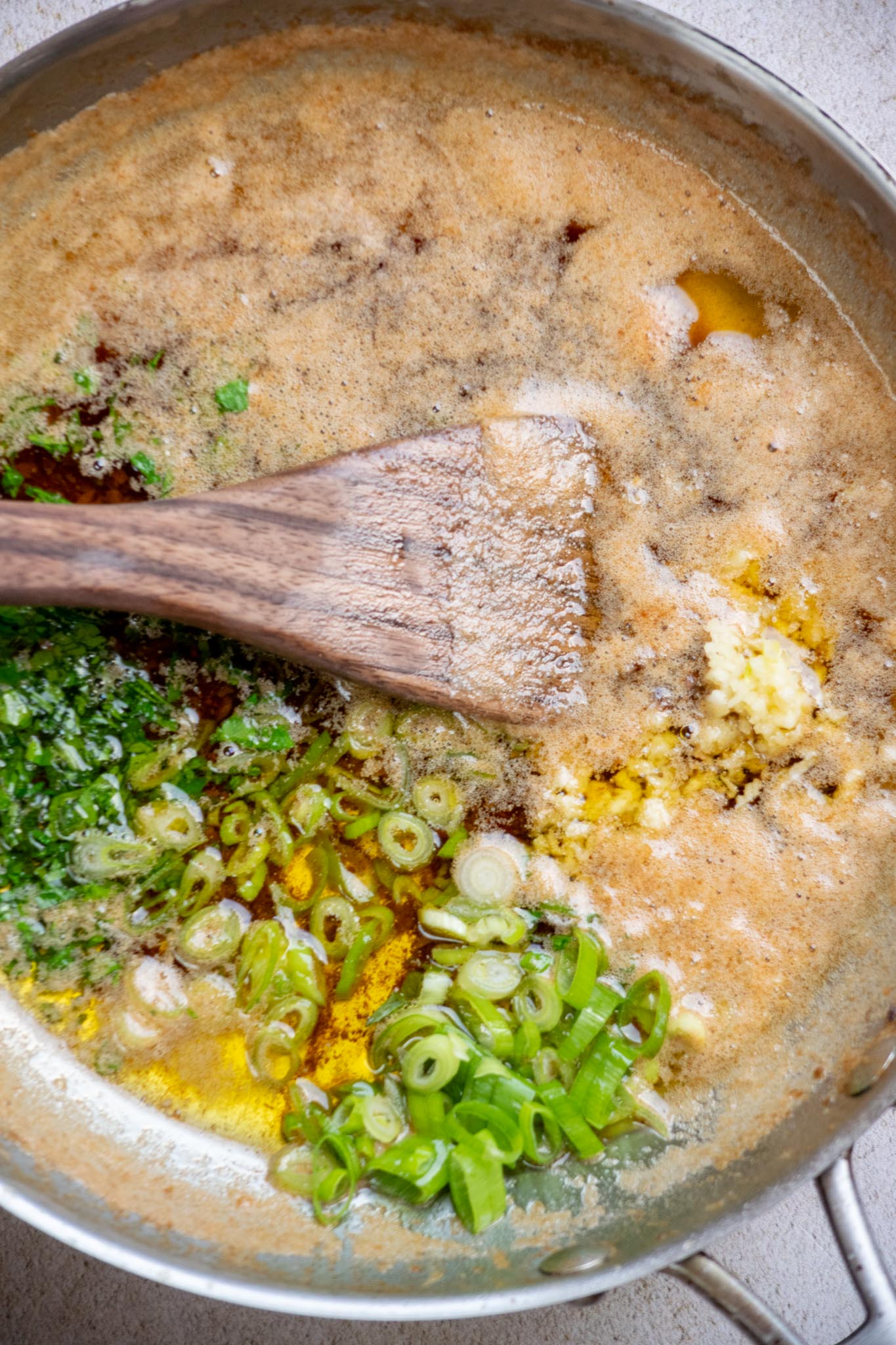 Stir in the scallion, parsley, and garlic until combined, then allow to cool for 2-3 minutes.