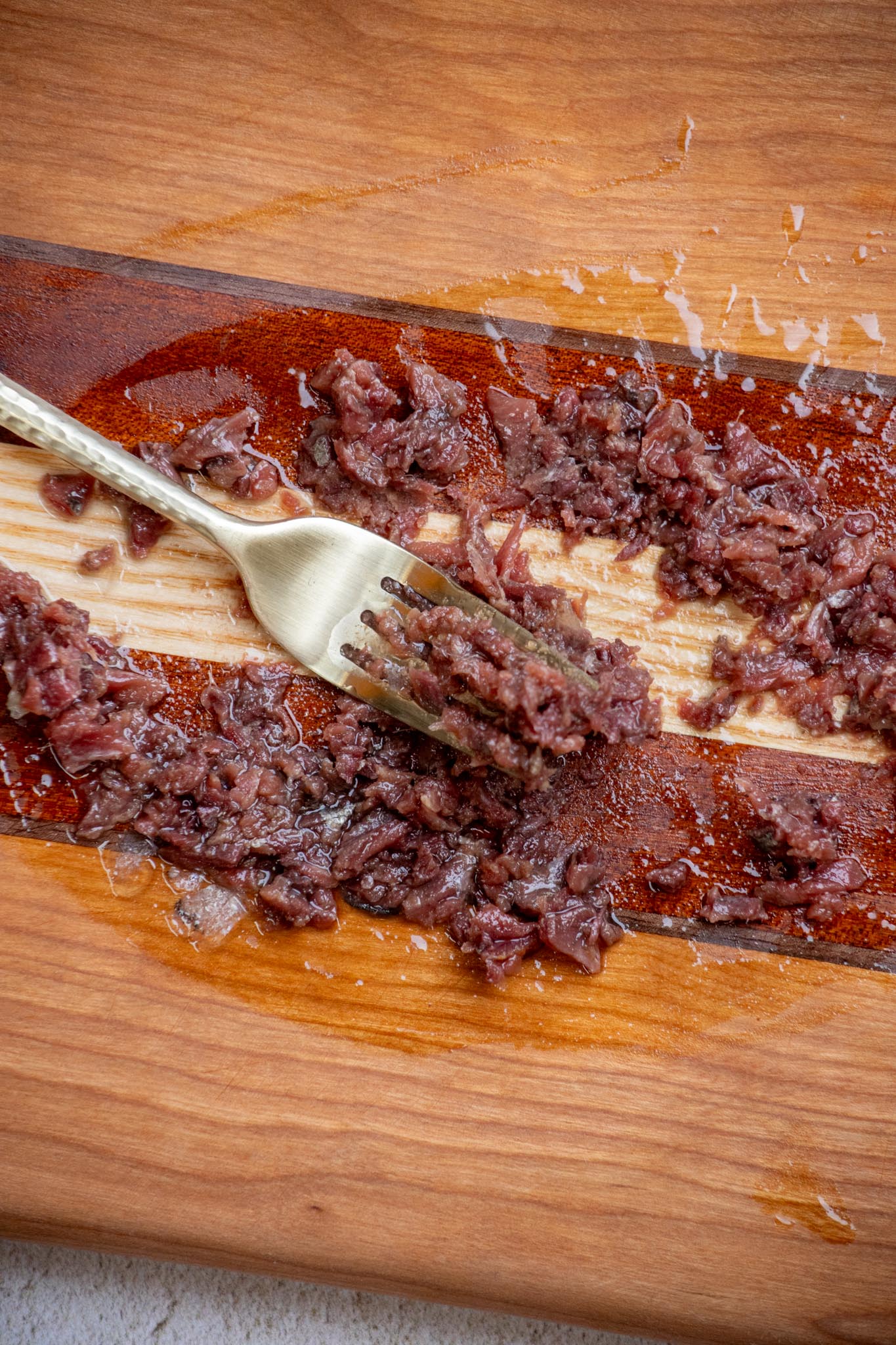 Finely mince the anchovies so they blend well into the butter.