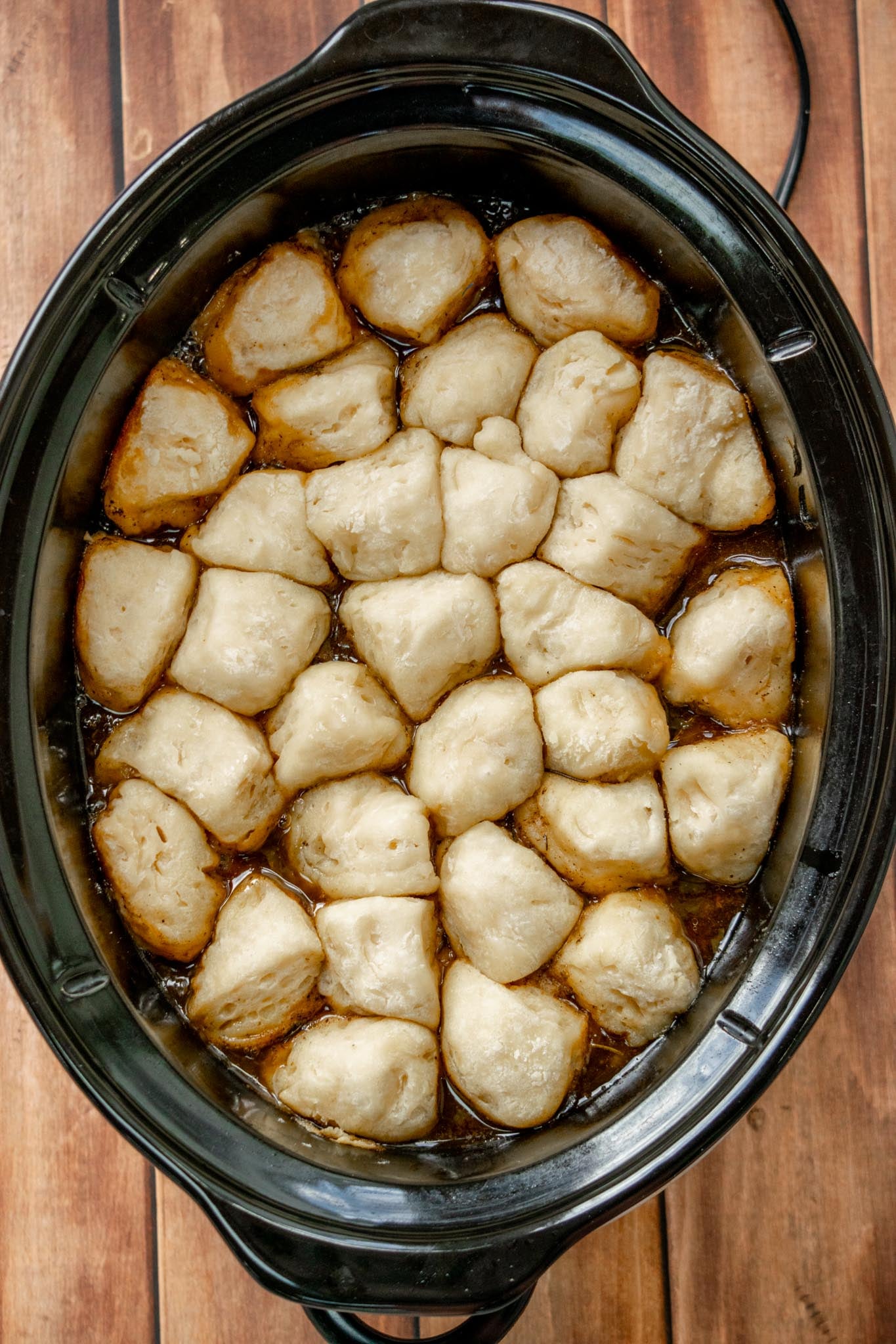 Cook the dumplings. Arrange the dumplings over the top of the hot stew. Cover and cook on HIGH for 40–45 minutes without stirring or lifting the lid. The dumplings should be puffed up and fluffy. Cut one in half to check that the center is fully cooked, with no wet or raw dough remaining. If needed, cover and cook a little longer. Remove the rosemary stems and bay leaves before serving.