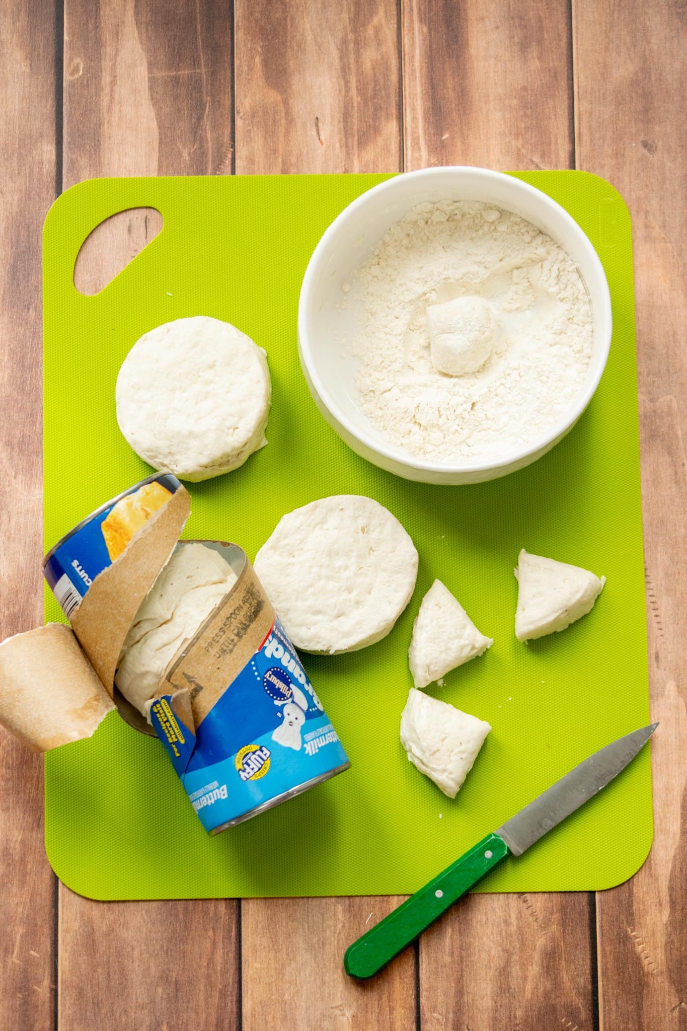 Prepare the biscuit dumplings. Once the stew is cooked, cut each refrigerated biscuit into 4 equal pieces. Gently roll each piece into a ball, then lightly coat in the reserved 2 tablespoons of flour. This helps the dumplings hold their shape and thickens the gravy as they cook.
