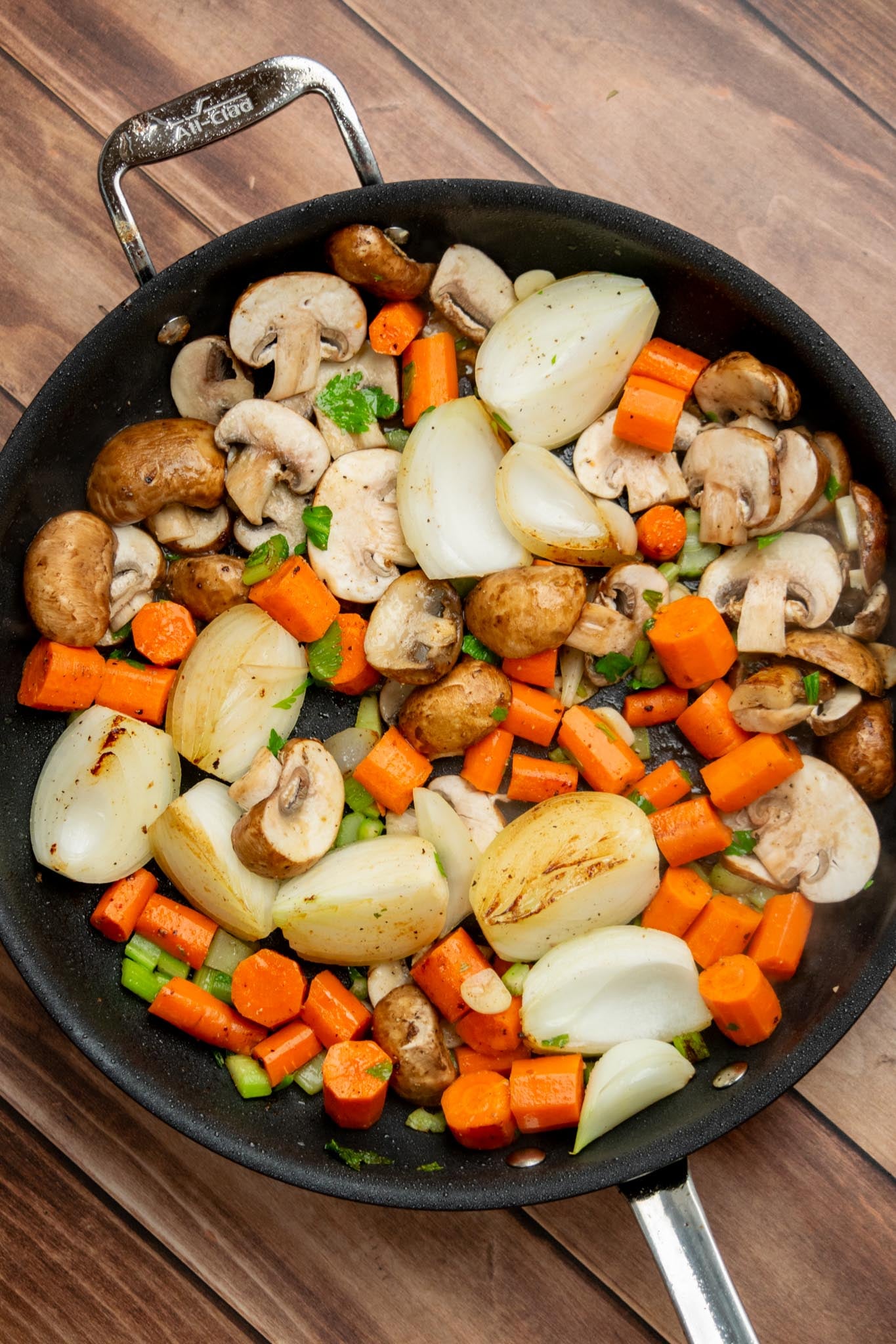 Brown the vegetables. Add the carrots, celery, mushrooms, onions, and garlic to the same skillet. Season with salt and pepper and cook for 2–3 minutes, letting the vegetables pick up some color and all those flavorful bits left behind by the beef. Transfer to the slow cooker.