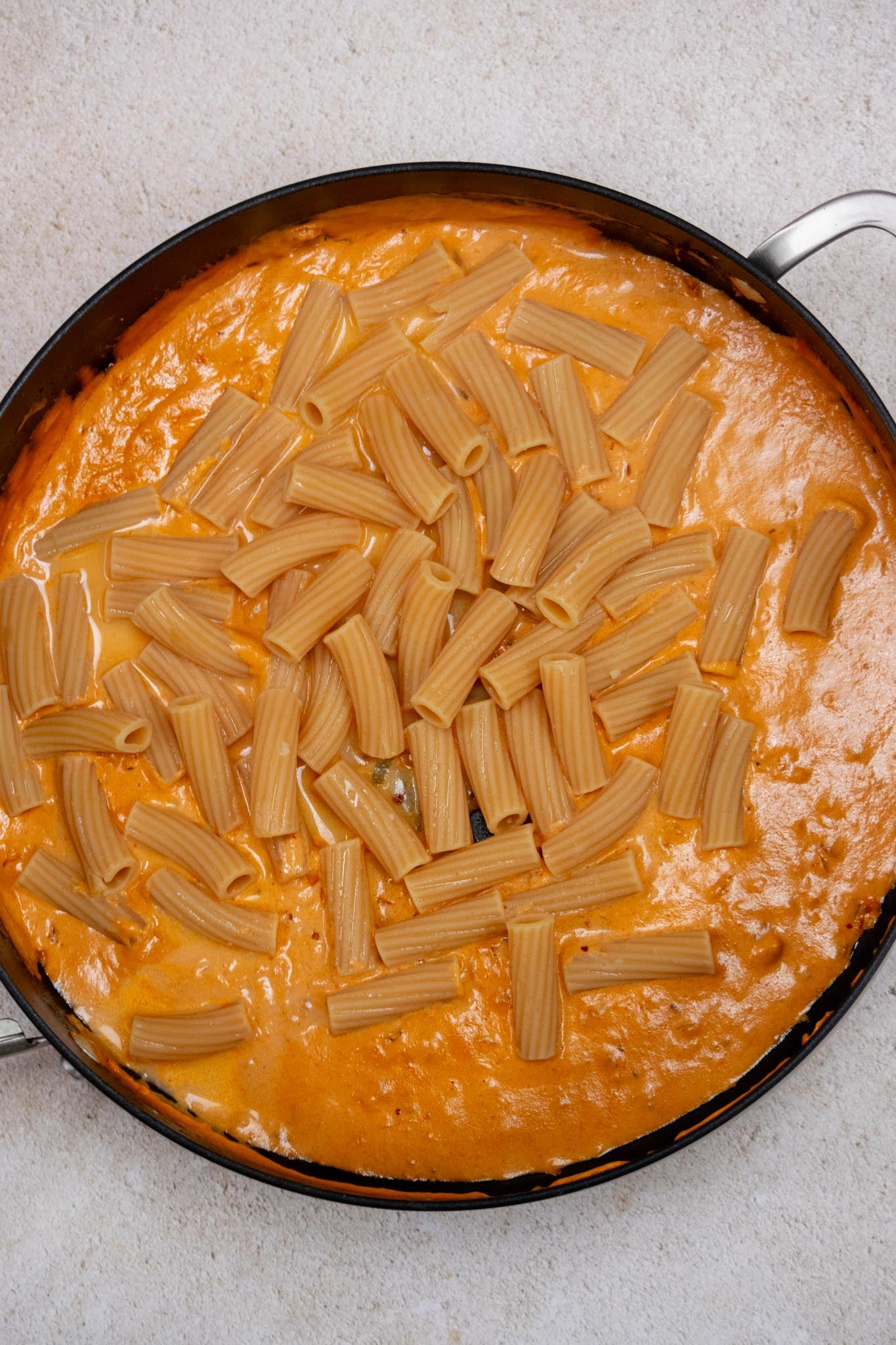 Add pasta and reserved pasta water; toss until evenly coated.