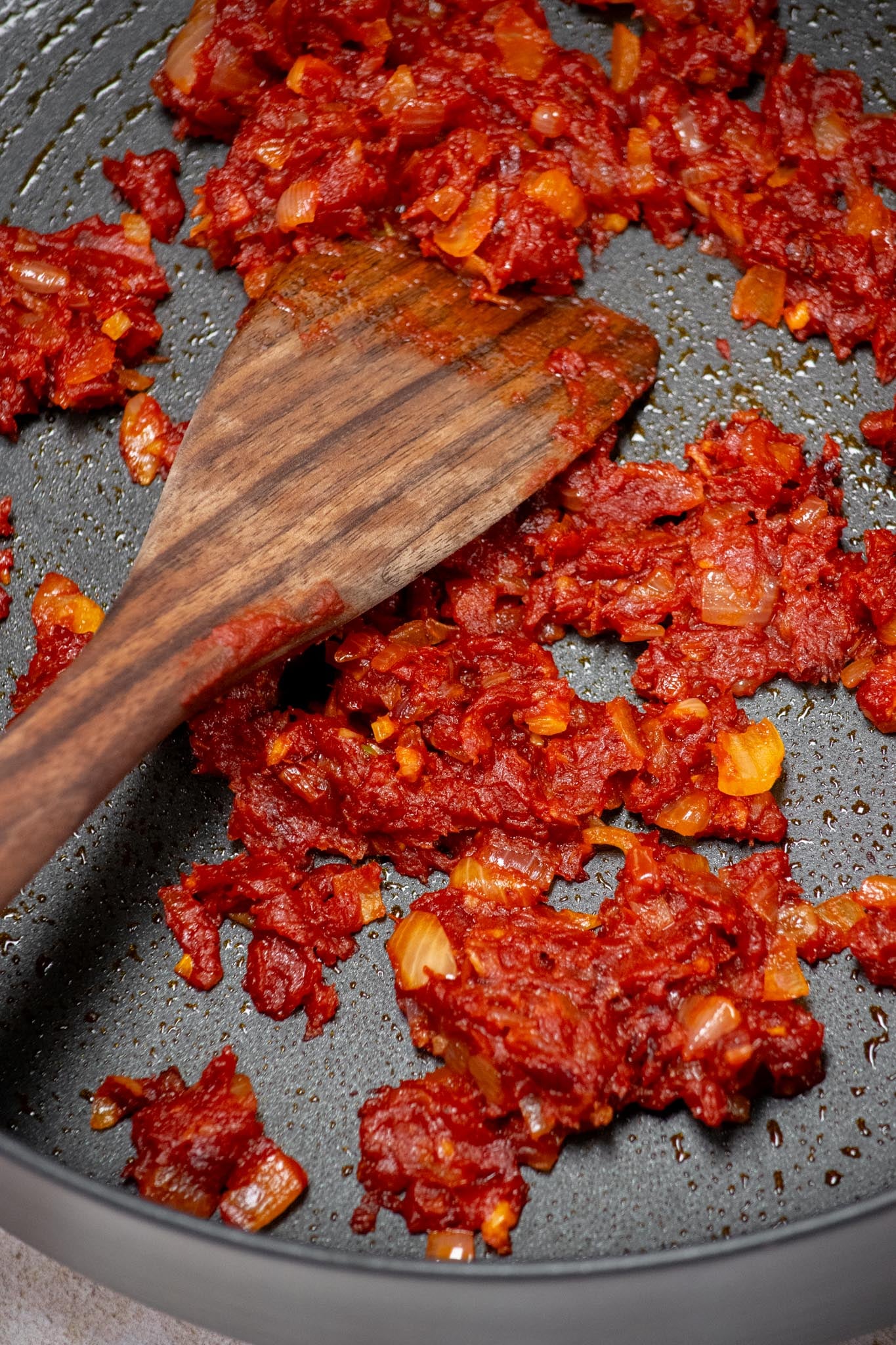 Add tomato paste and cook for 5 minutes, stirring occasionally, until deep red.